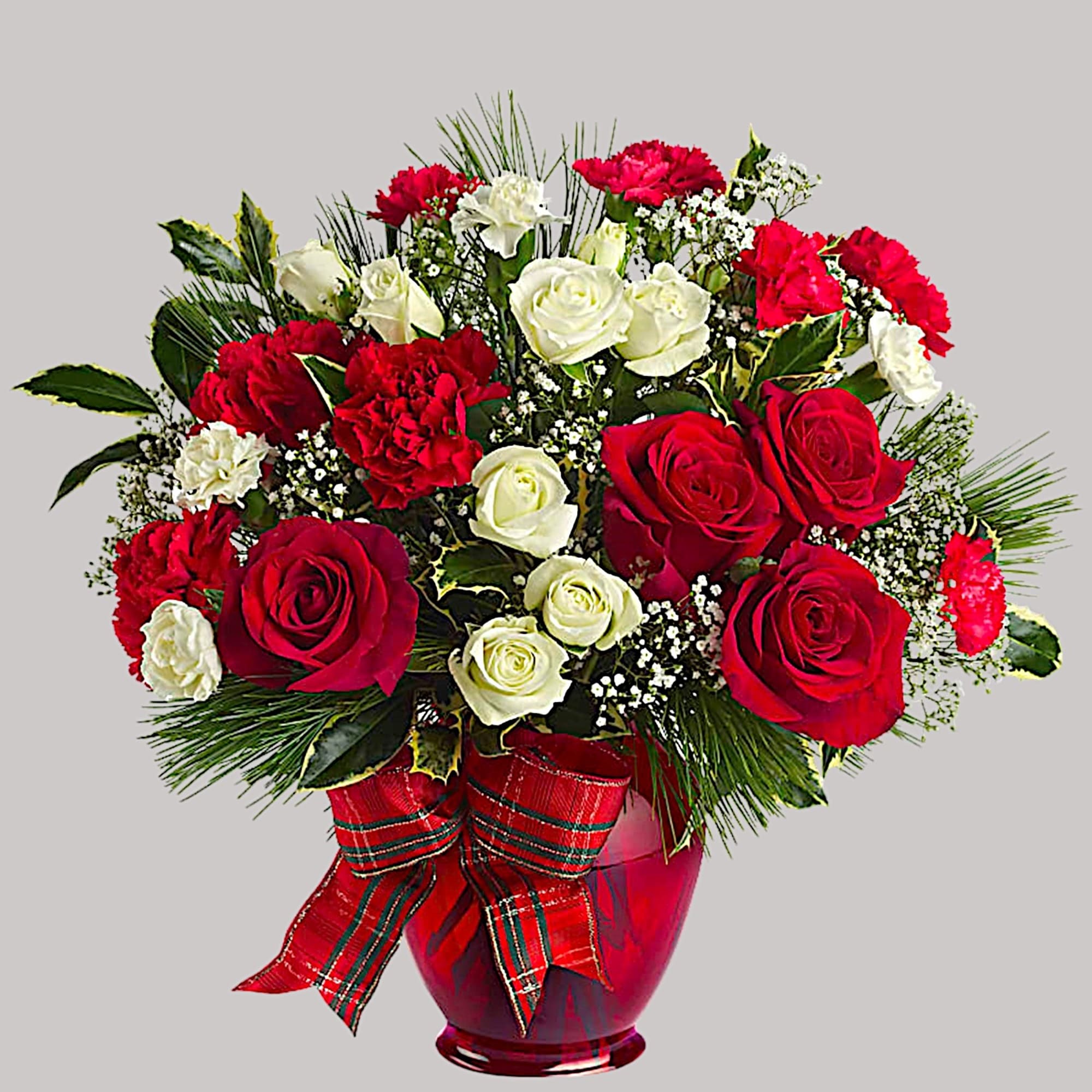 All dressed up in classic Christmas colors, this holiday floral arrangement is