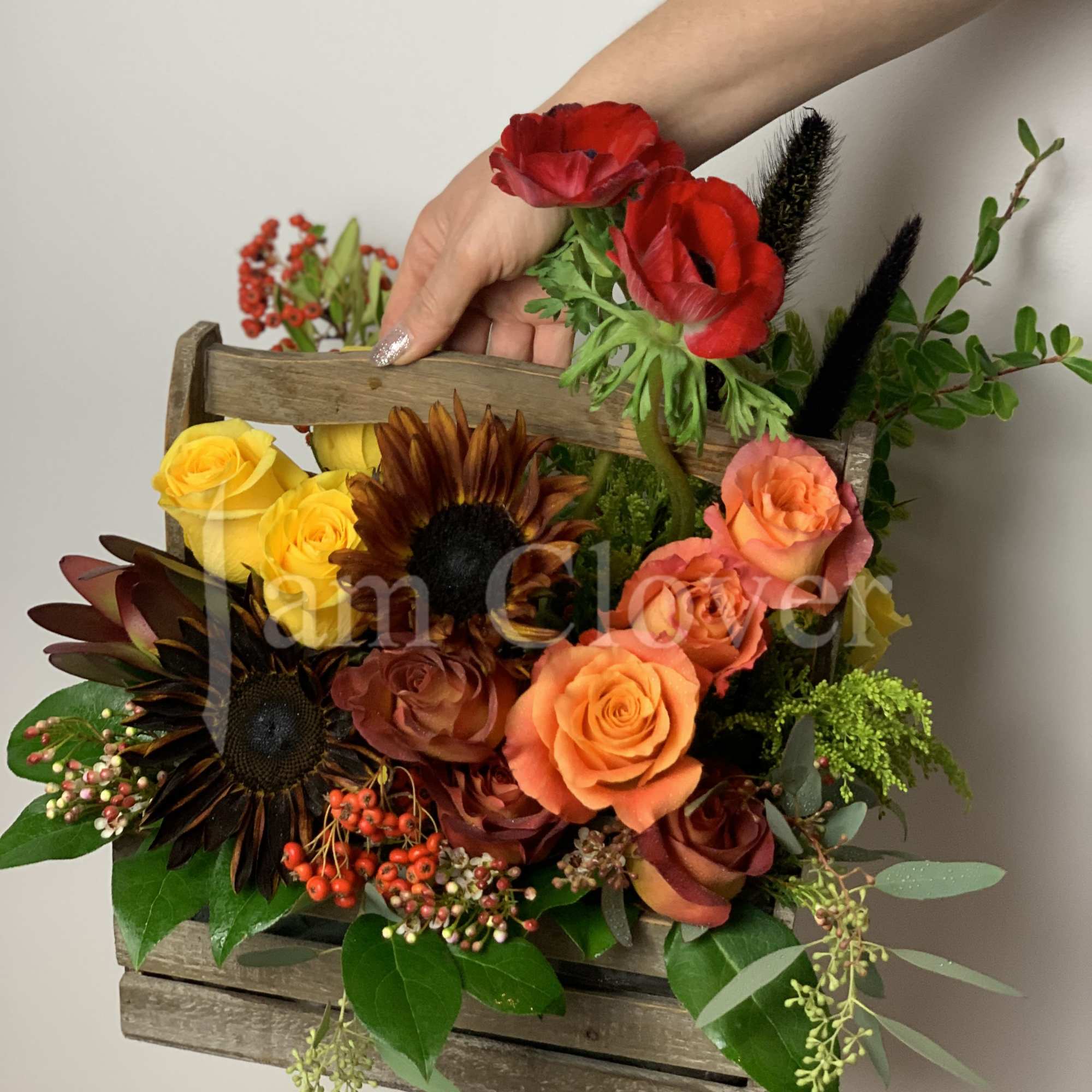 A beautiful rich in color and texture wood basket full of flowers.