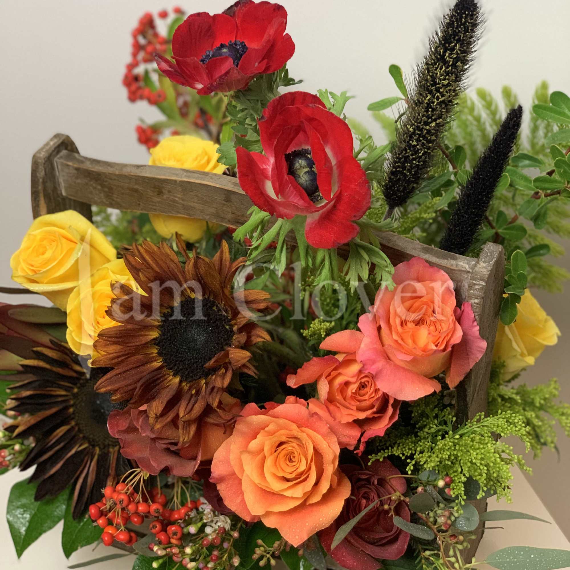 A beautiful rich in color and texture wood basket full of flowers.