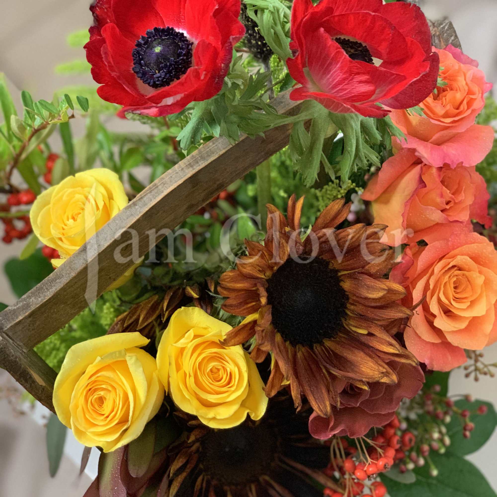 A beautiful rich in color and texture wood basket full of flowers.