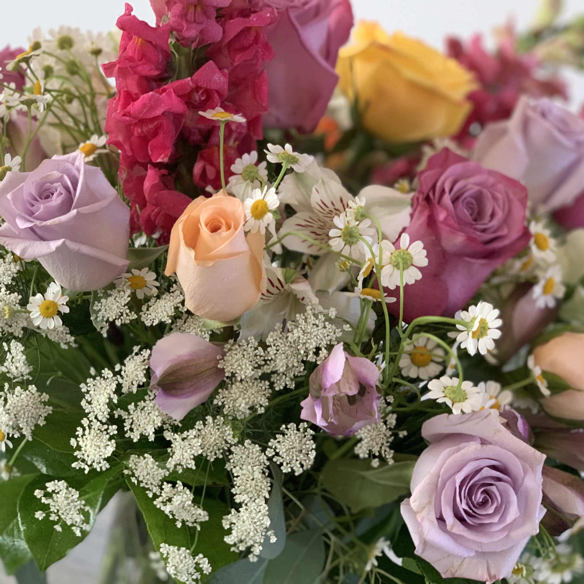 This Bouquet combines a variety of  flowers like: lavender, peach, magenta