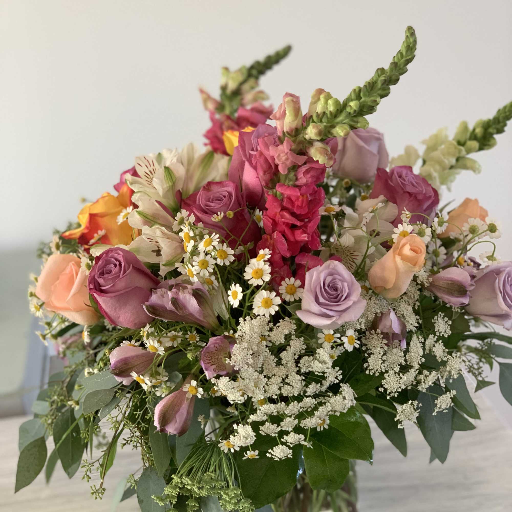 This Bouquet combines a variety of  flowers like: lavender, peach, magenta