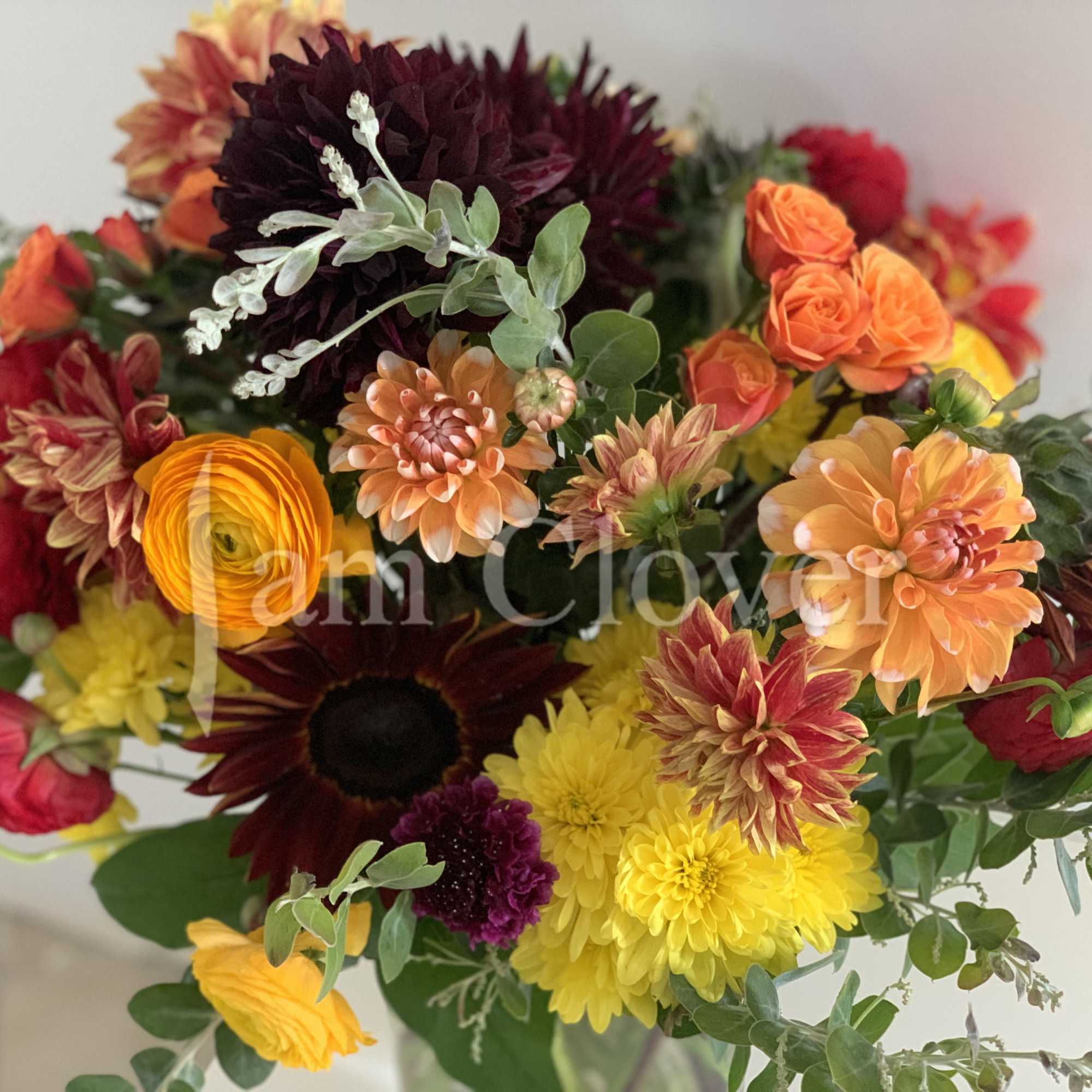 This autumn bouquet captures the warm, rich hues of the season, blending
