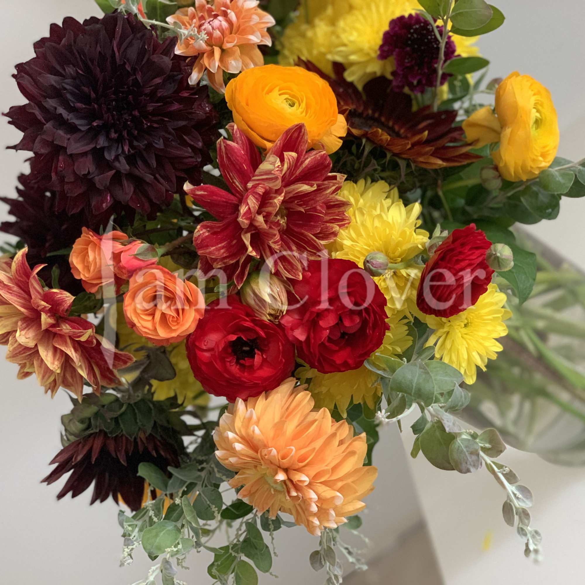 This autumn bouquet captures the warm, rich hues of the season, blending