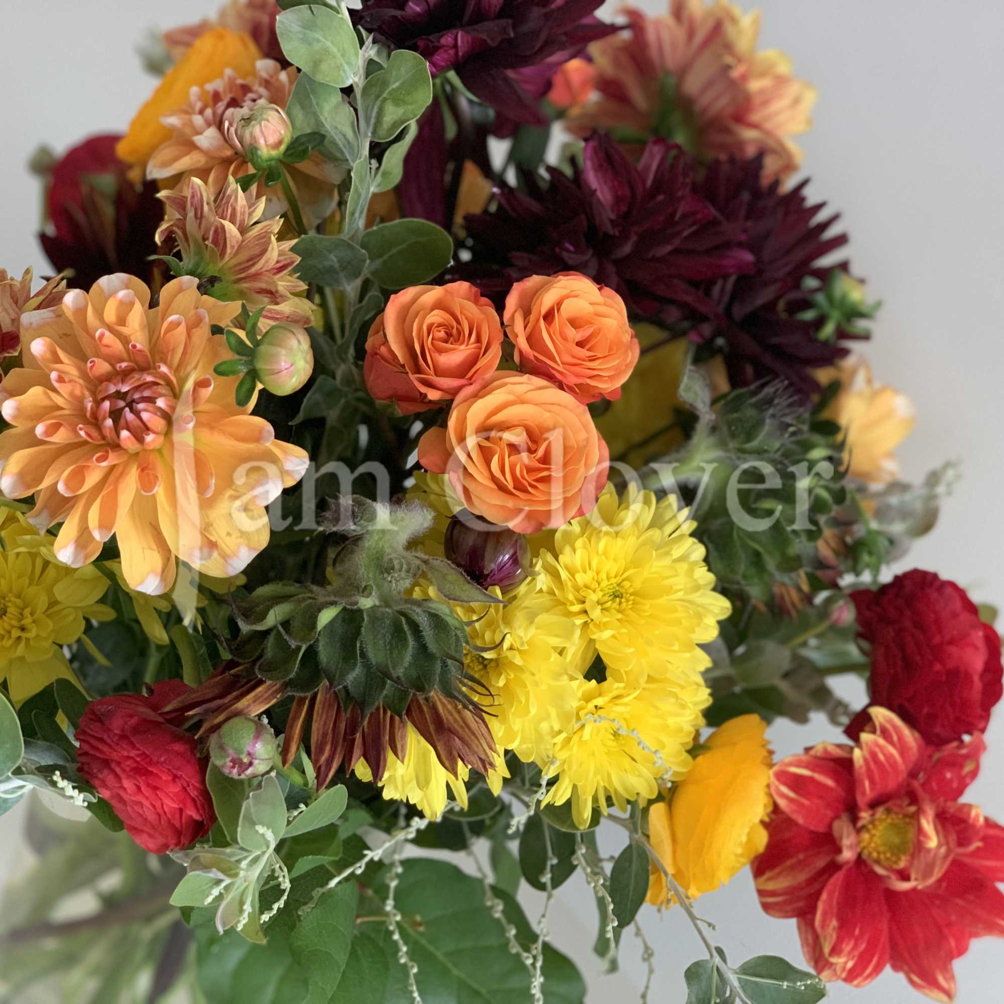 This autumn bouquet captures the warm, rich hues of the season, blending
