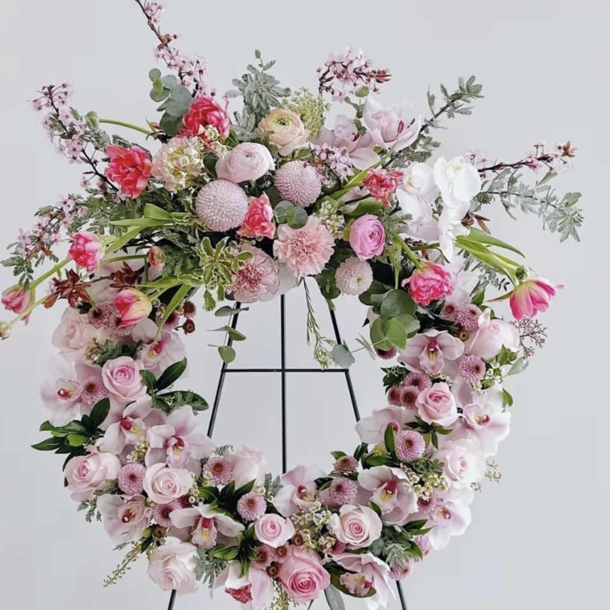 Adorn your loved ones tribute with a display of  pretty pink