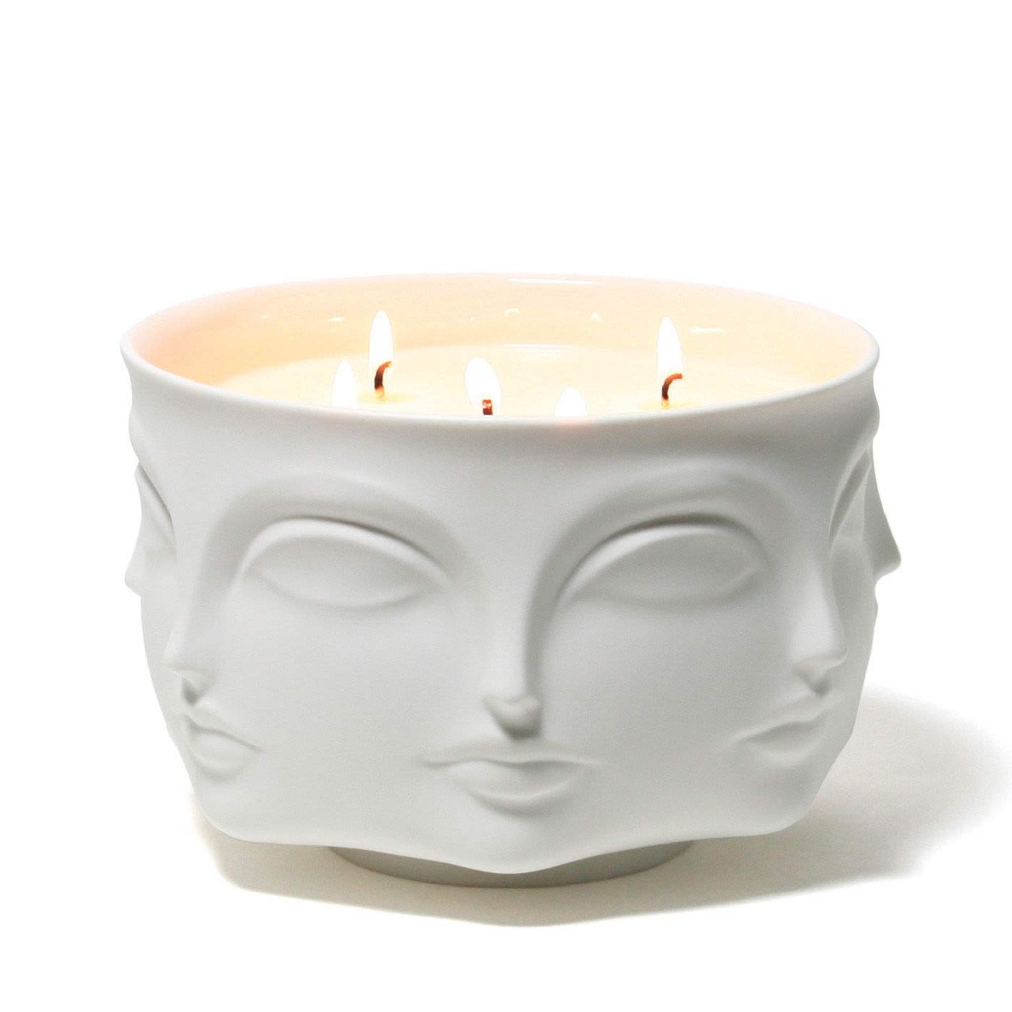 A crisp floral candle in a translucent porcelain vessel that glows when