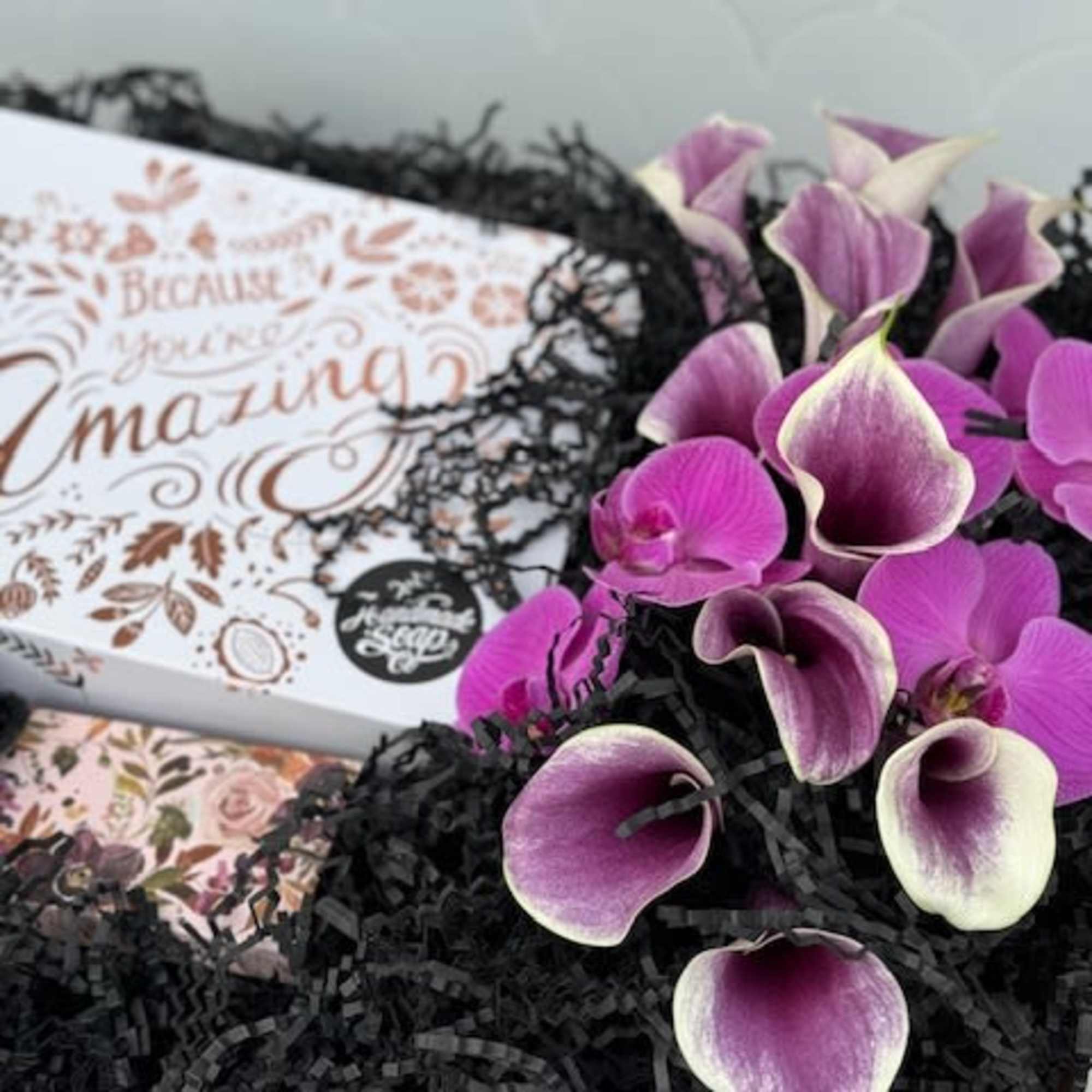 A beautiful display in a wooden crate filled with purple florals, and A beautiful display in a wooden crate filled with purple florals, and