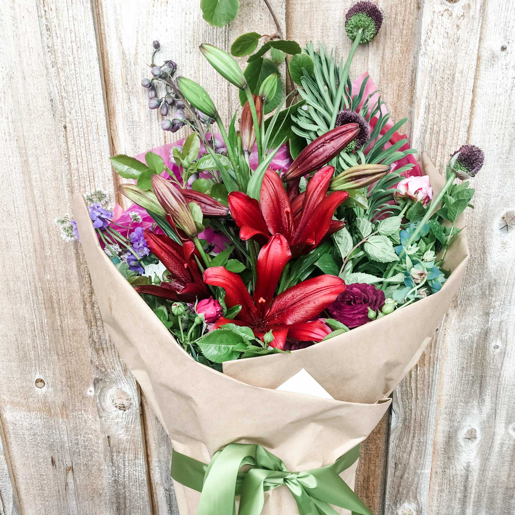 This arm load of blossoms in a seasonal pallet will make her