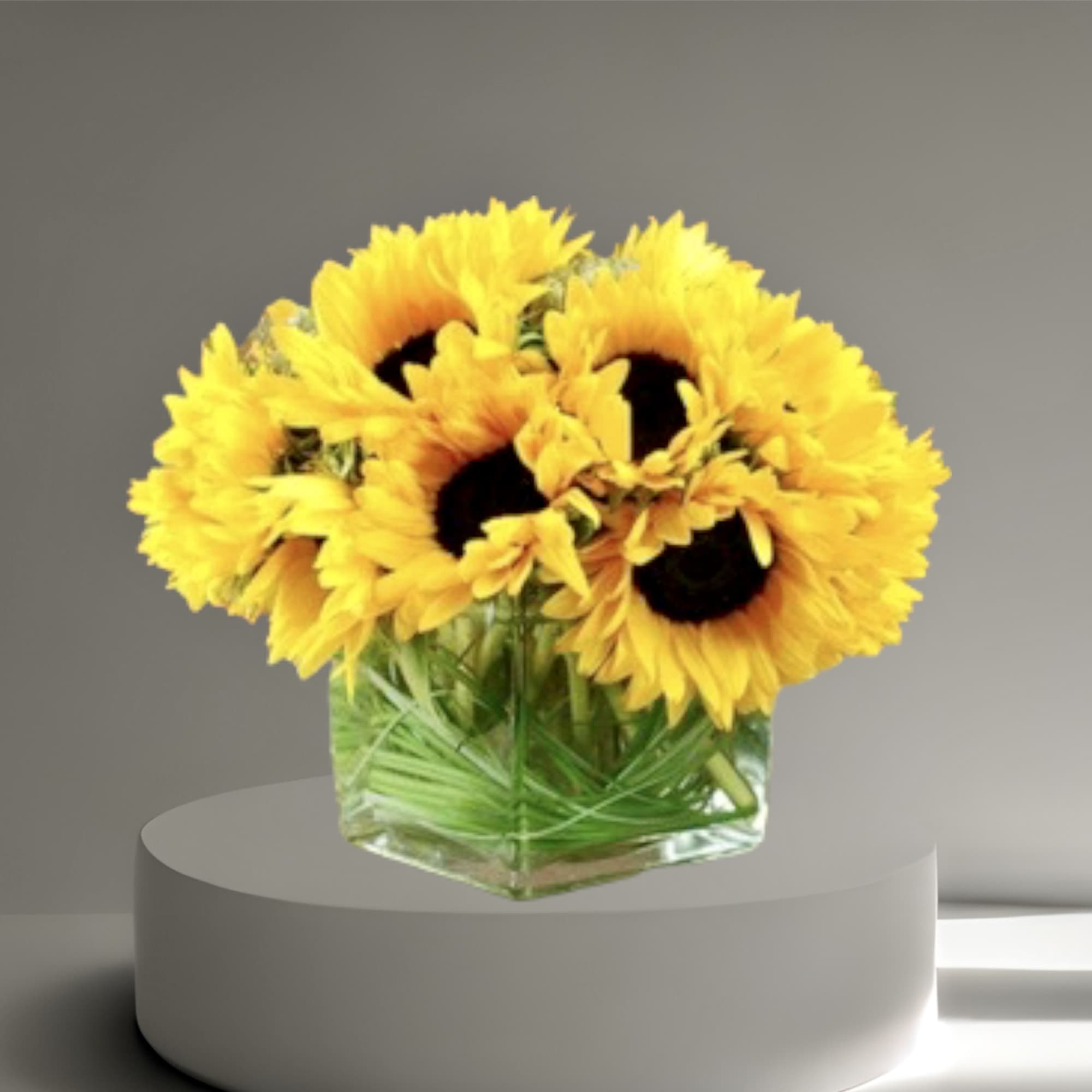 A best seller! Sun Flower arrangement in a glass vase, with other