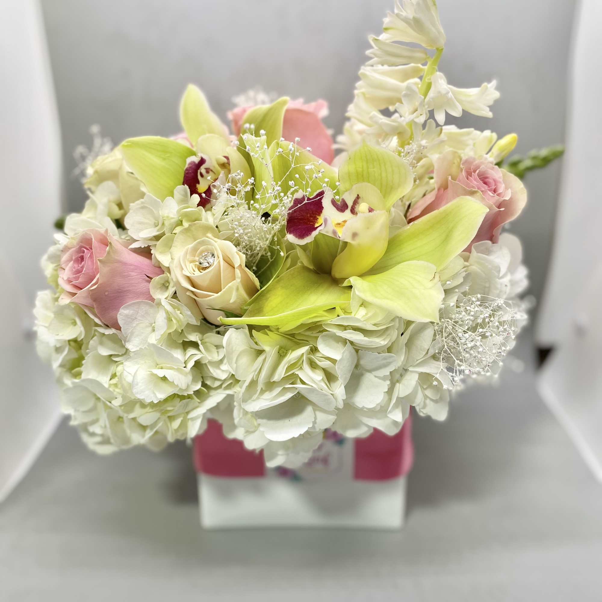 medium size floral in white glass vase fill with fabulist seasonal flowers
