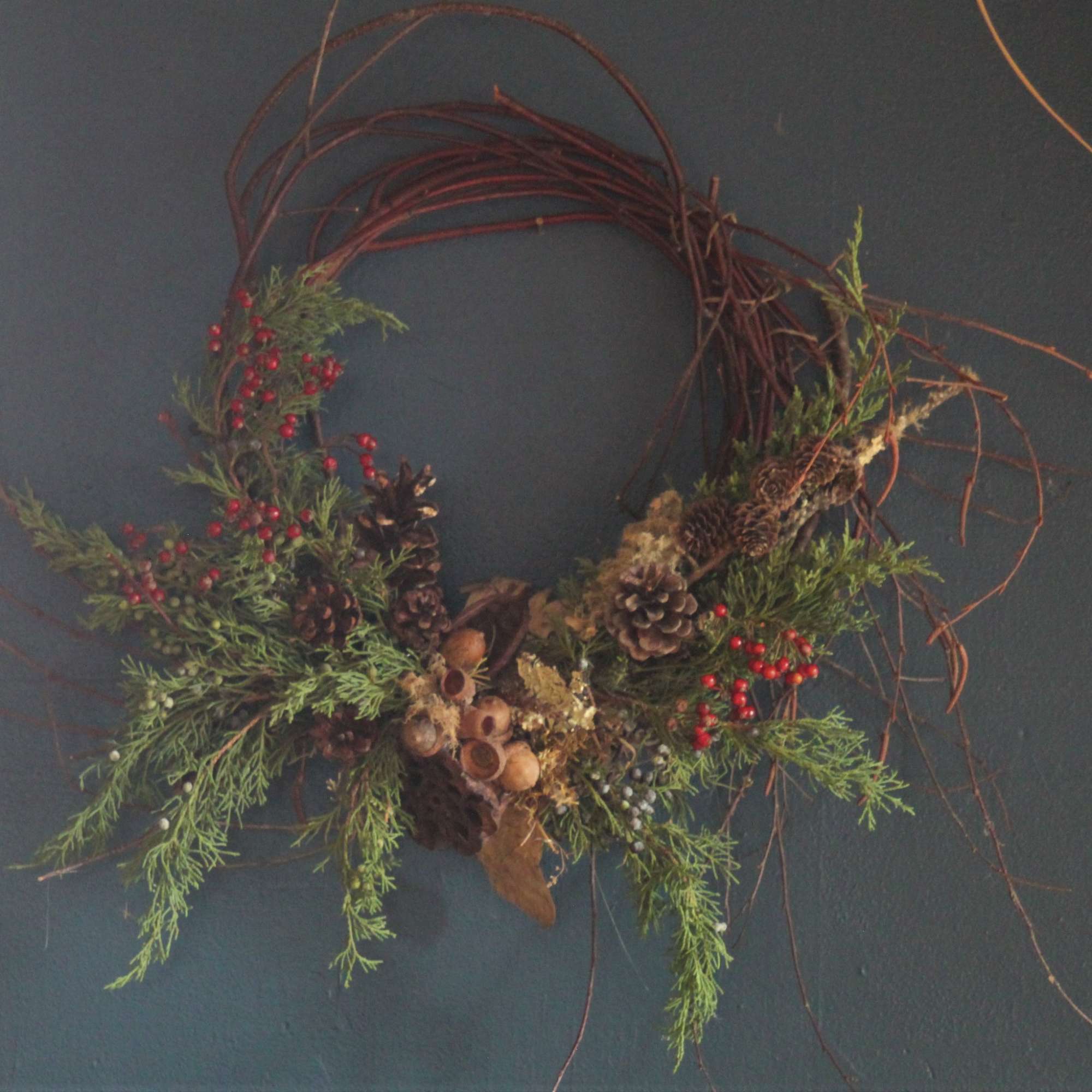 A wreath made up of seasonal sticks and twigs and interesting dried