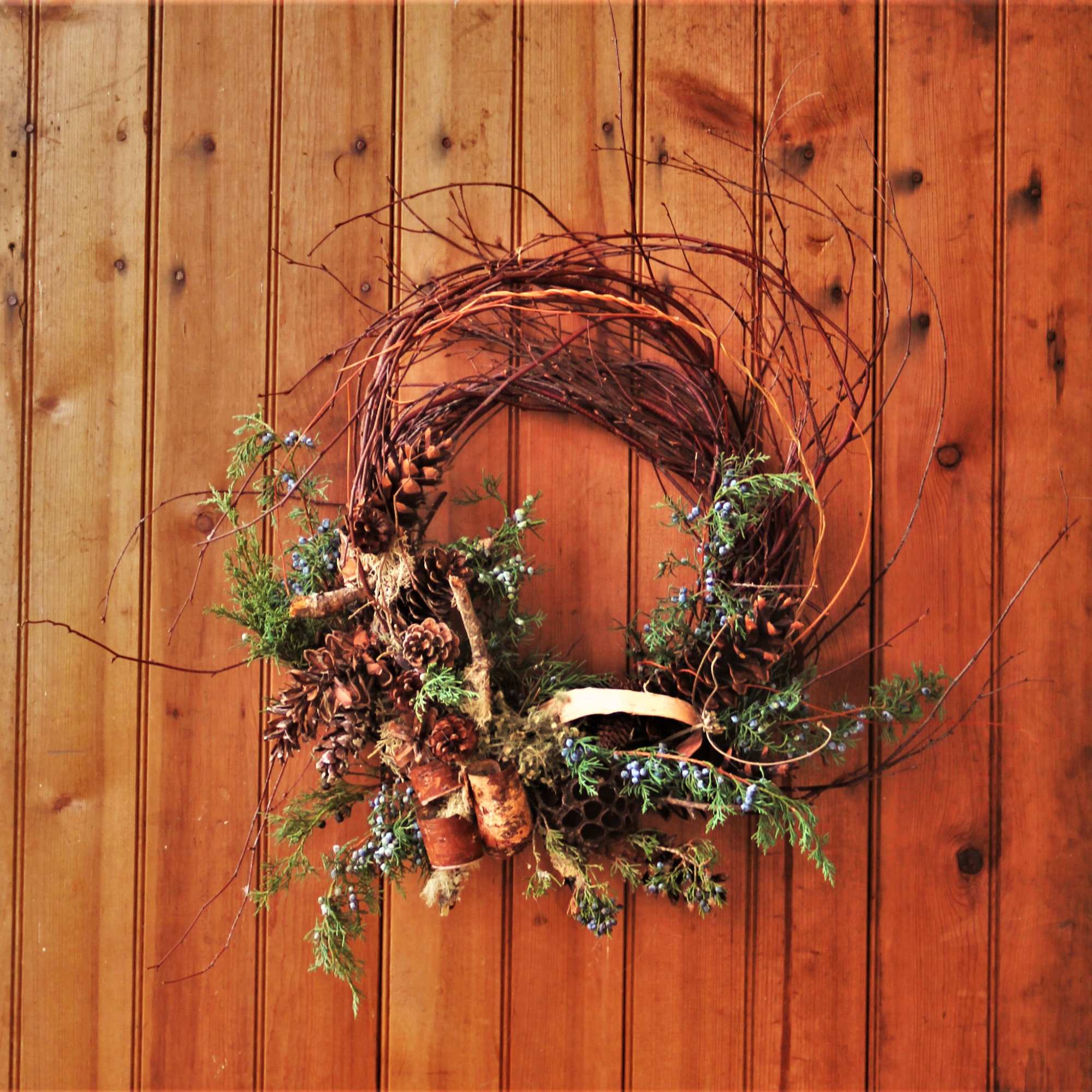 A wreath made up of seasonal sticks and twigs and interesting dried