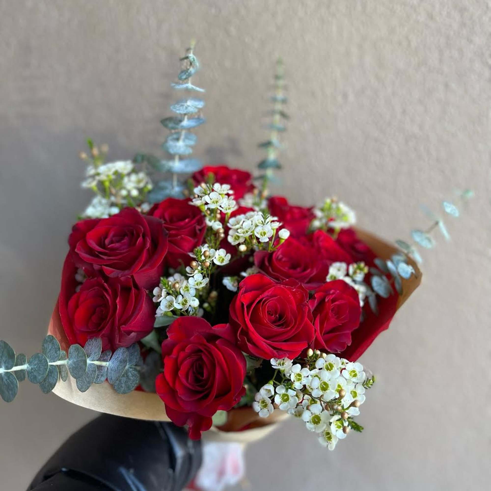 A hand tied bouquet of a dozen red roses for your sweetie.