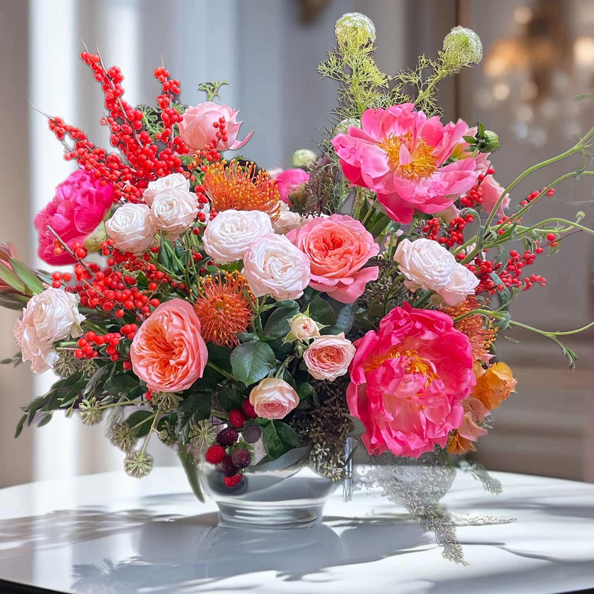 In this enchanting floral arrangement, the delicate beauty of peonies and true