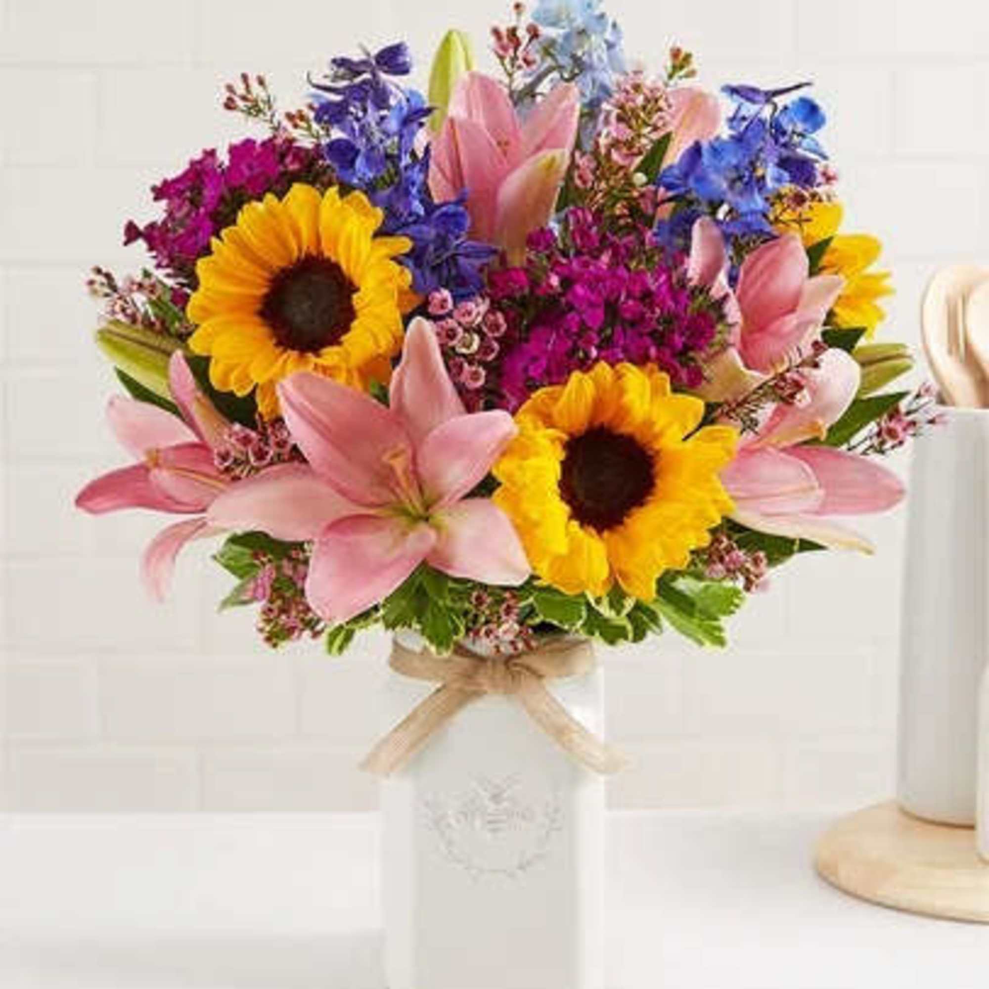 Get them buzzing with our charming bouquet! Sunflowers, Pink Asiatic Lily, Blue