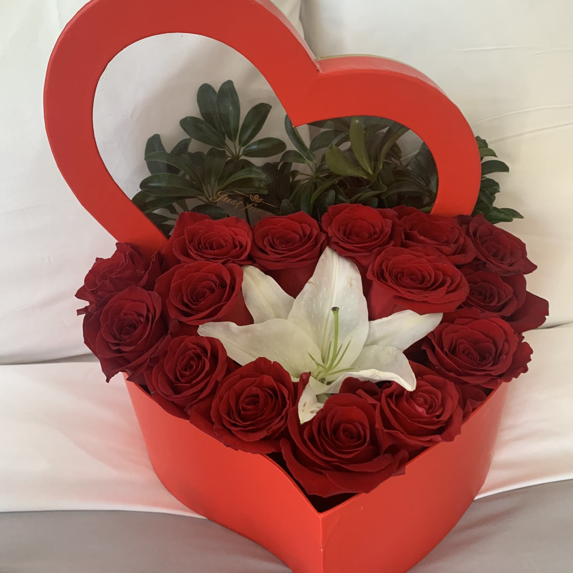 Box of heart shape fill with premium red roses accent with a