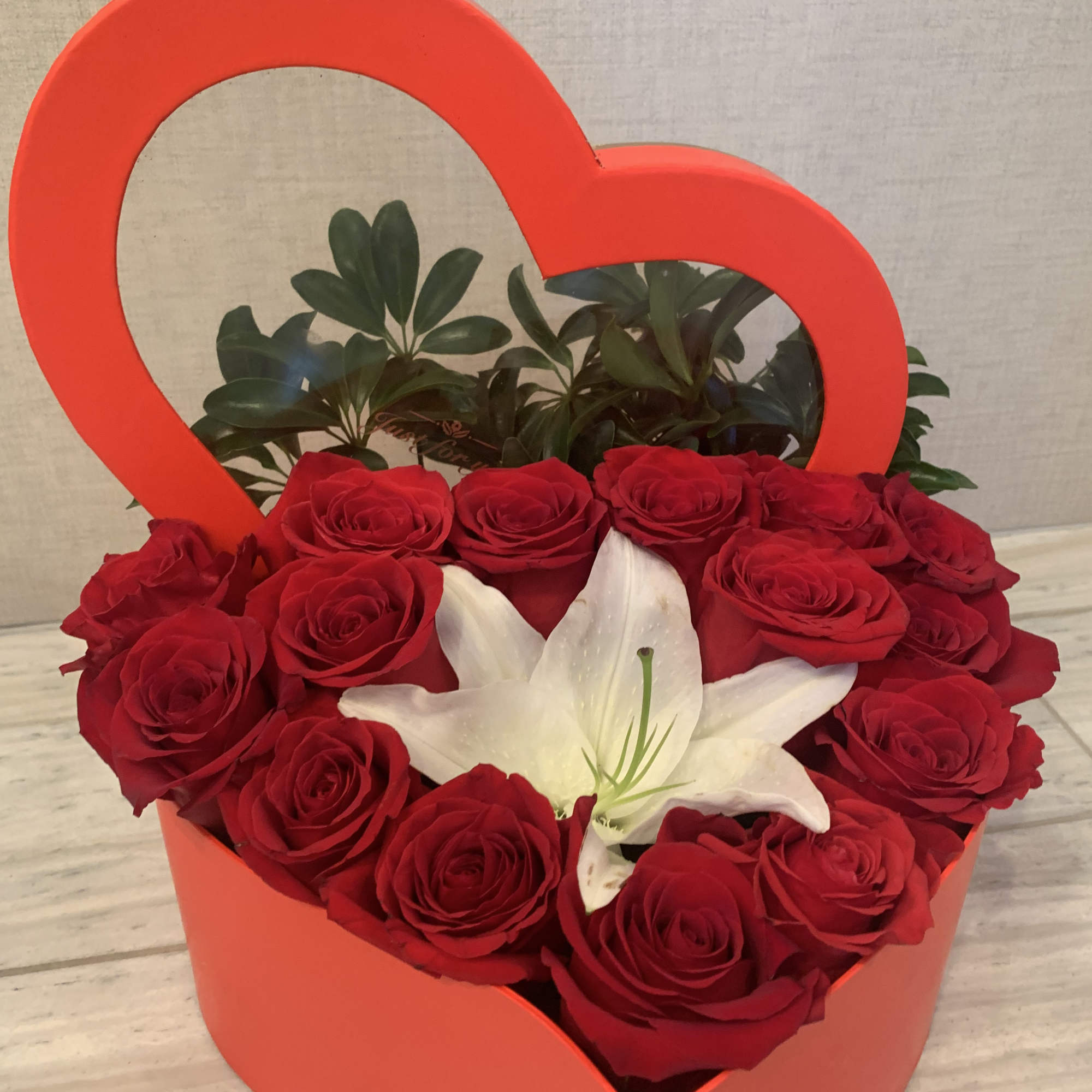 Box of heart shape fill with premium red roses accent with a