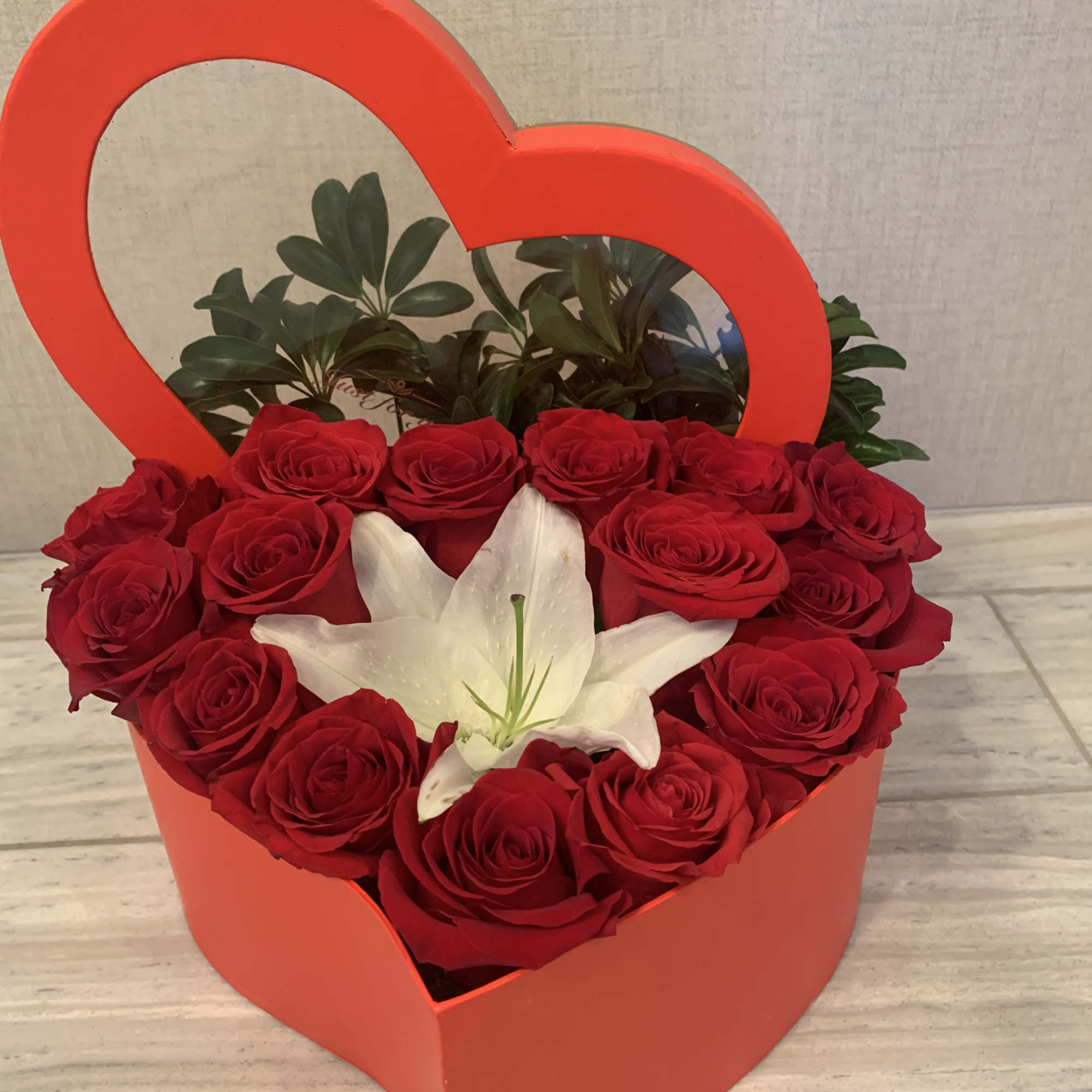 Box of heart shape fill with premium red roses accent with a