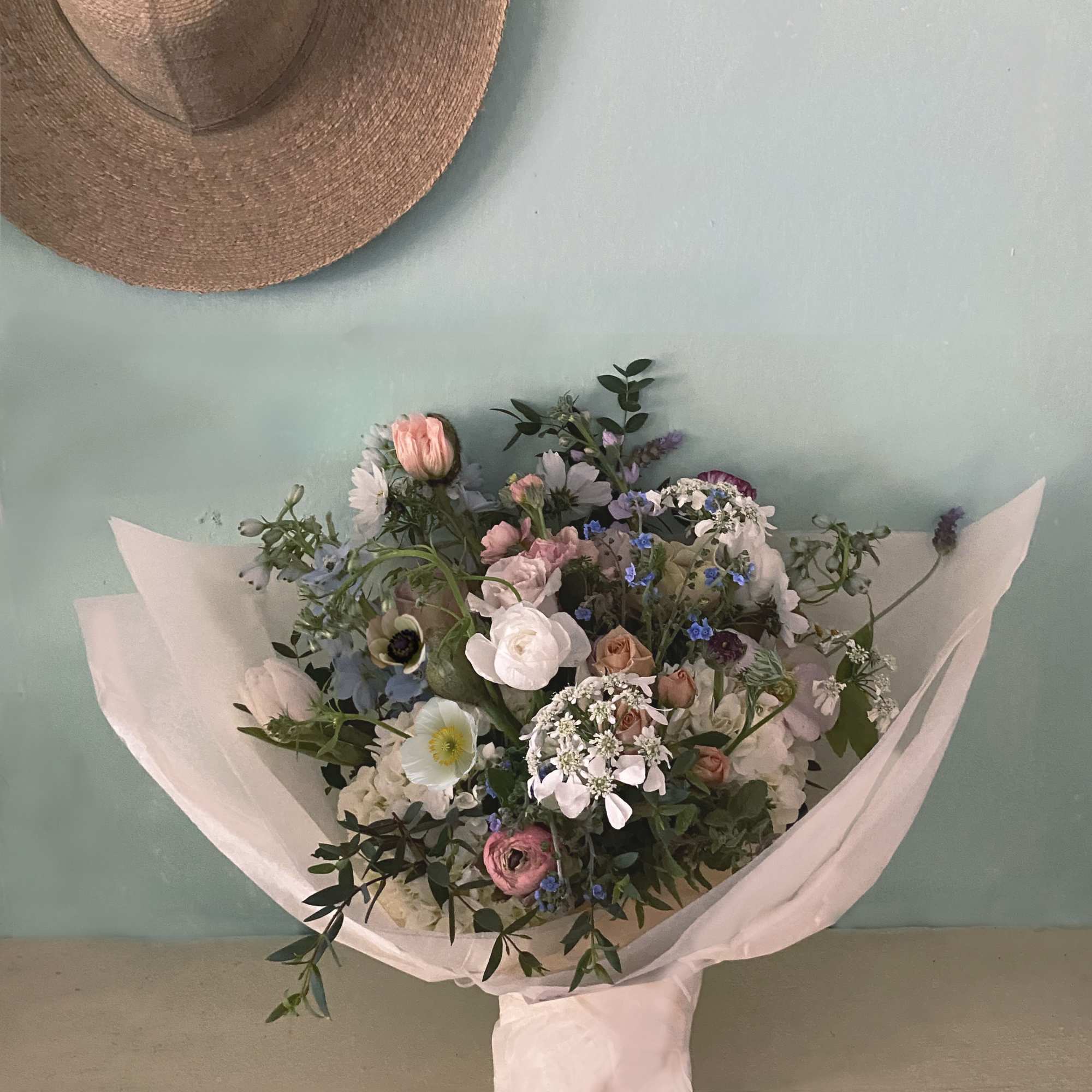 A gorgeous wild bouquet of natural stems including pretty nuances of blue.