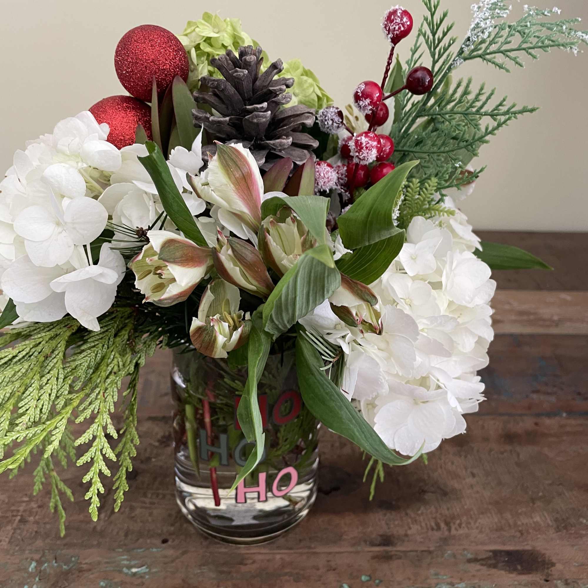 White and green hydrangea, alstromeria, berries and cones
