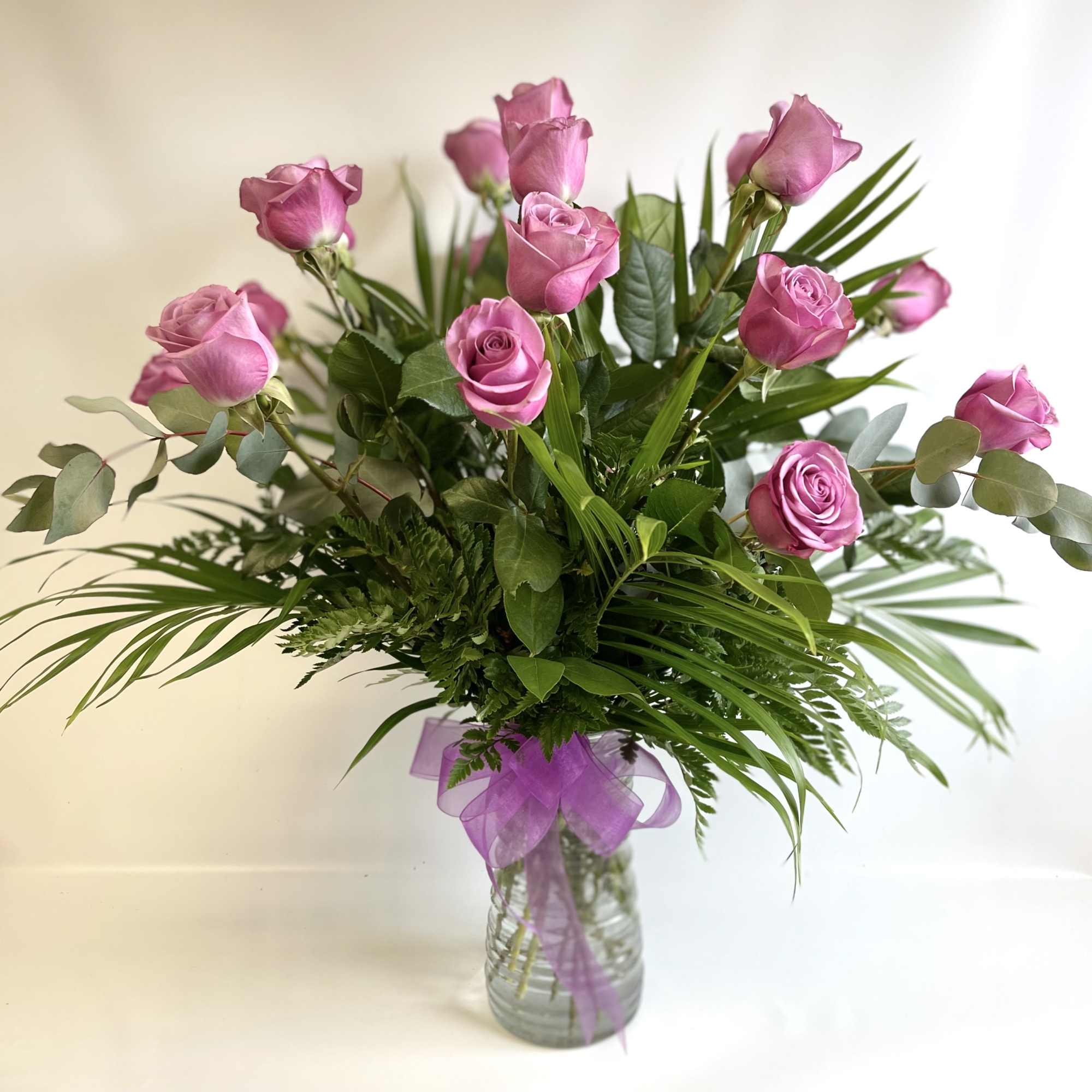 18 Lavender Roses beautifully arranged in a vase. PREMIUM includes higher end 18 Lavender Roses beautifully arranged in a vase. PREMIUM includes higher end