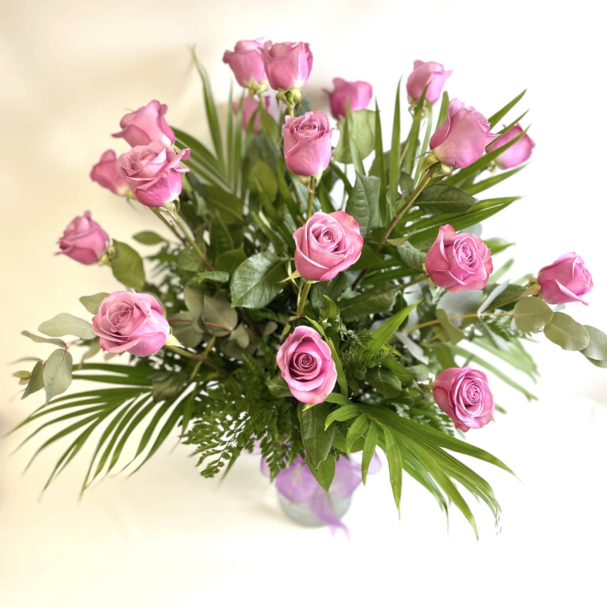 18 Lavender Roses beautifully arranged in a vase. PREMIUM includes higher end 18 Lavender Roses beautifully arranged in a vase. PREMIUM includes higher end