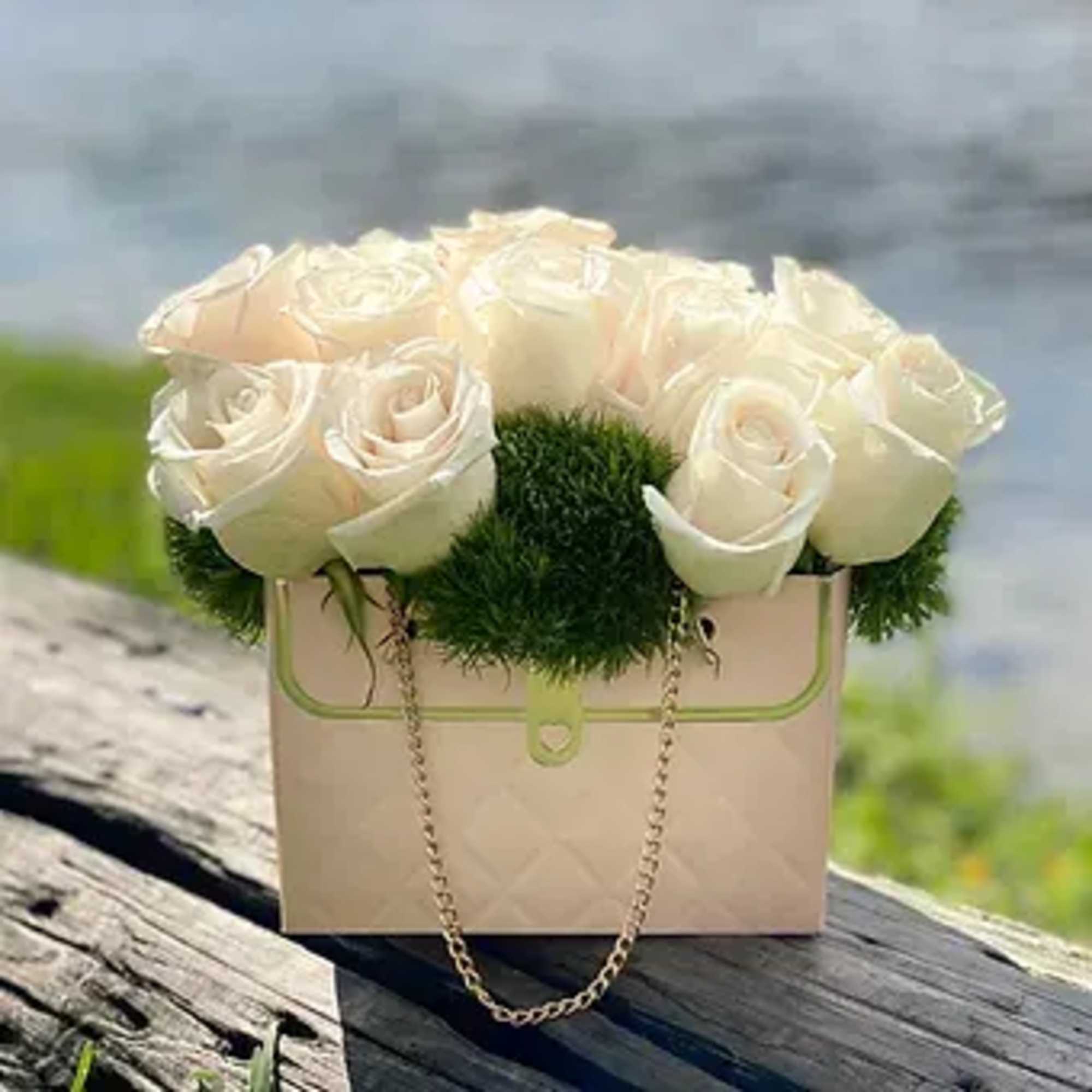 A bouquet in a stylish small handbag is an elegant and original