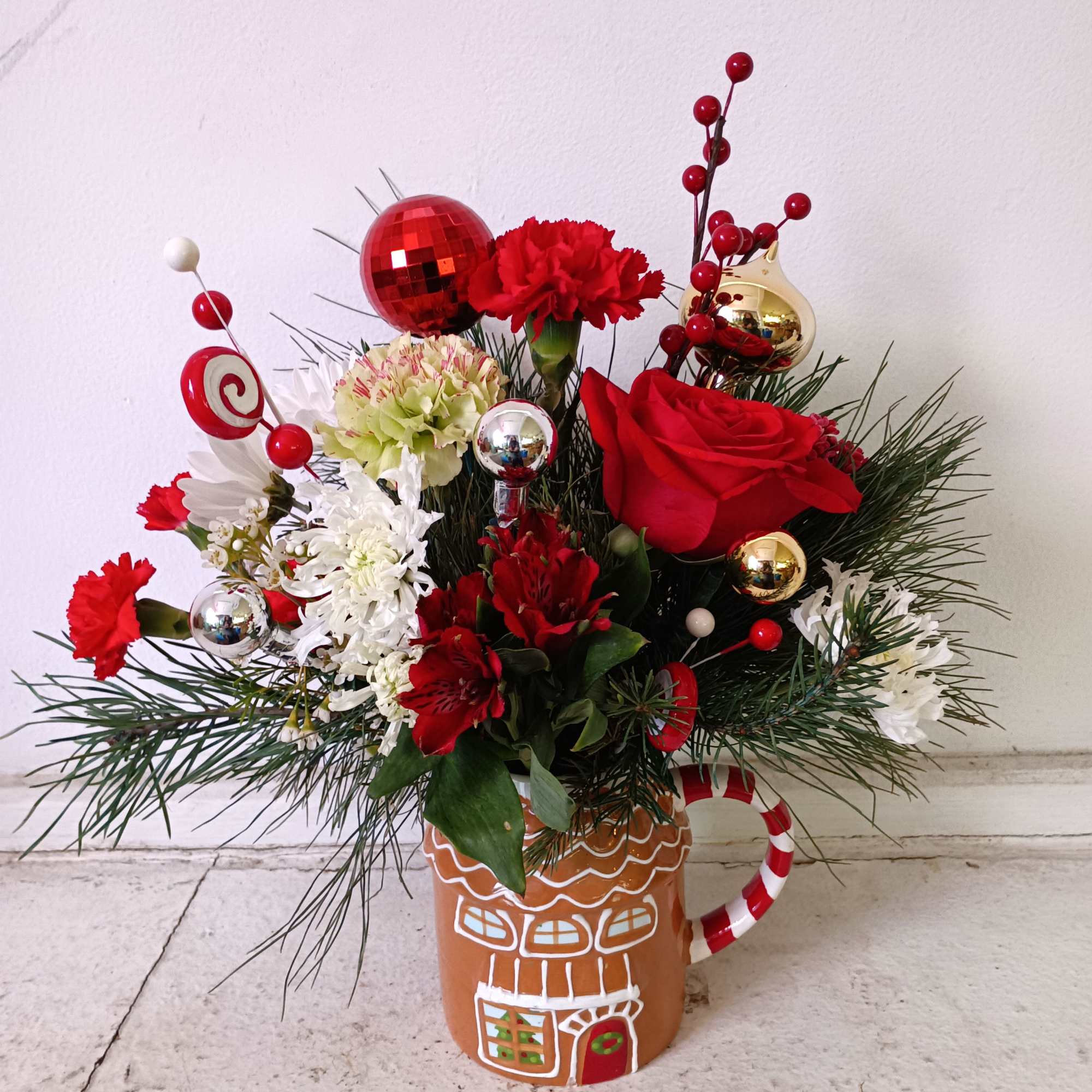 Bright and sparling Christmas colors ornaments with rea flowers and pine brunches