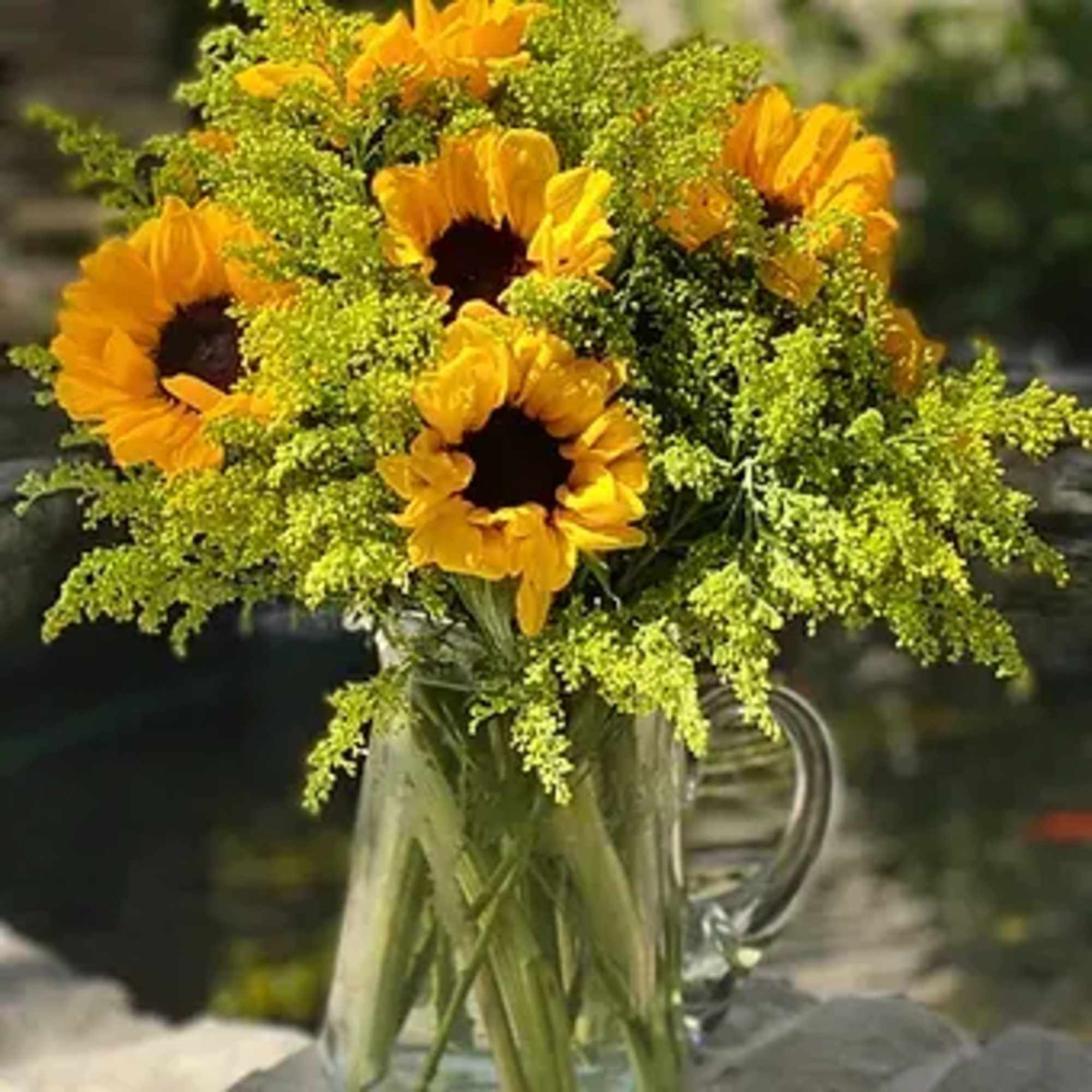 Order a bright bouquet of sunflowers in a stylish vase - we