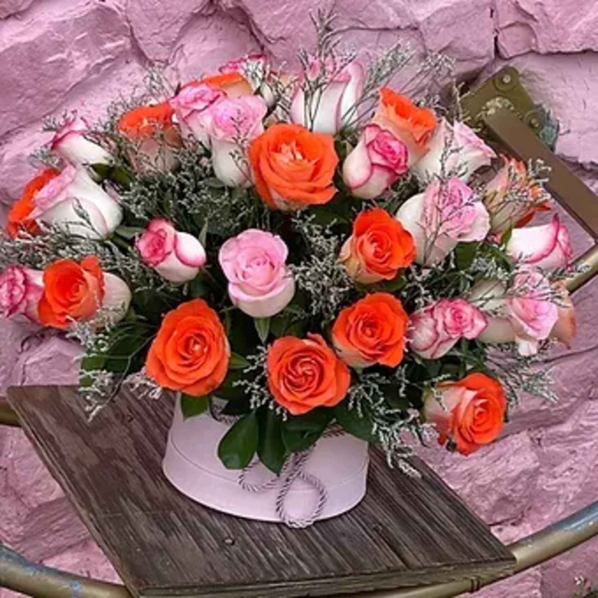 An exquisite box filled with luxurious red and delicate pink roses is