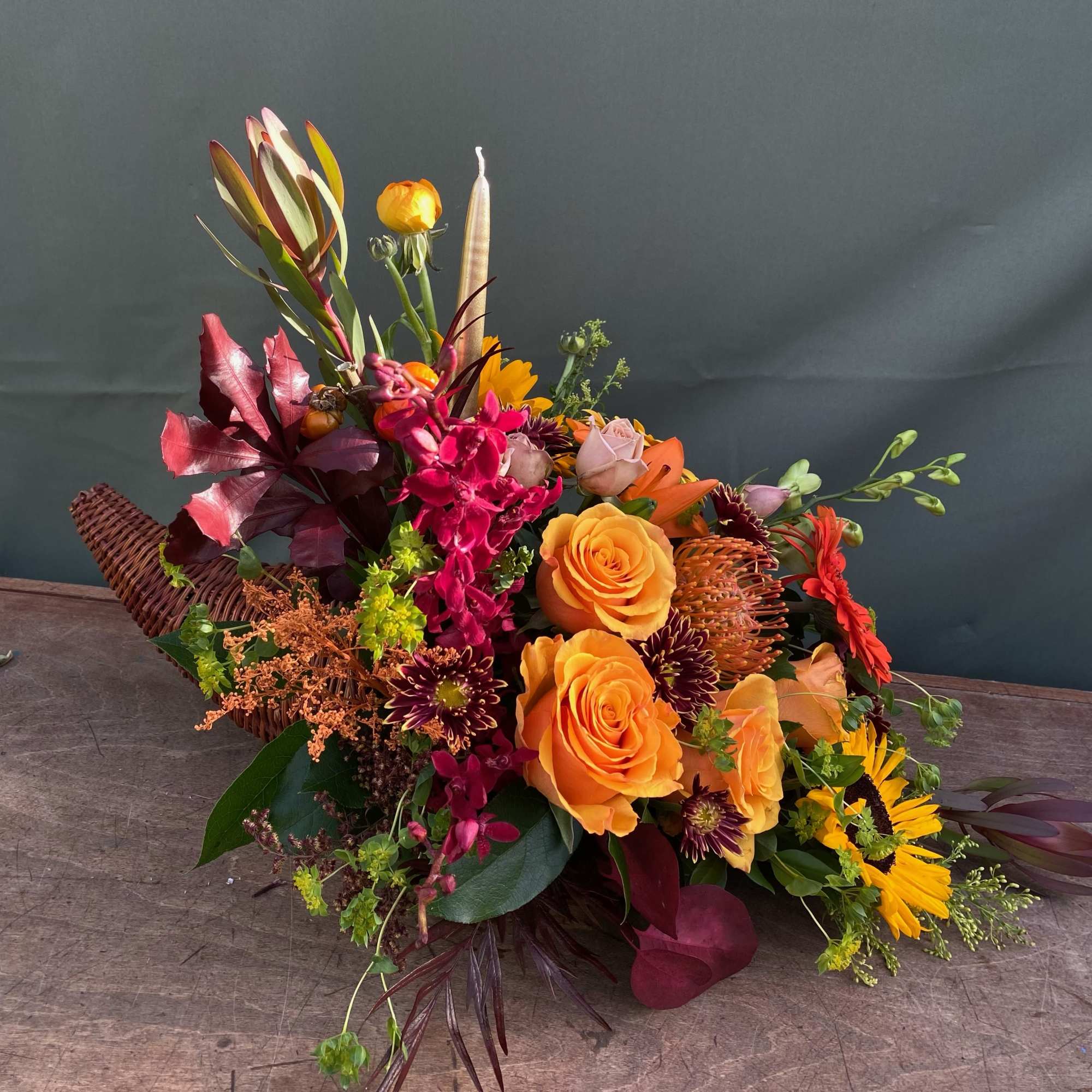 This arrangement include a variety of fall flowers, perfect for your thanksgiving