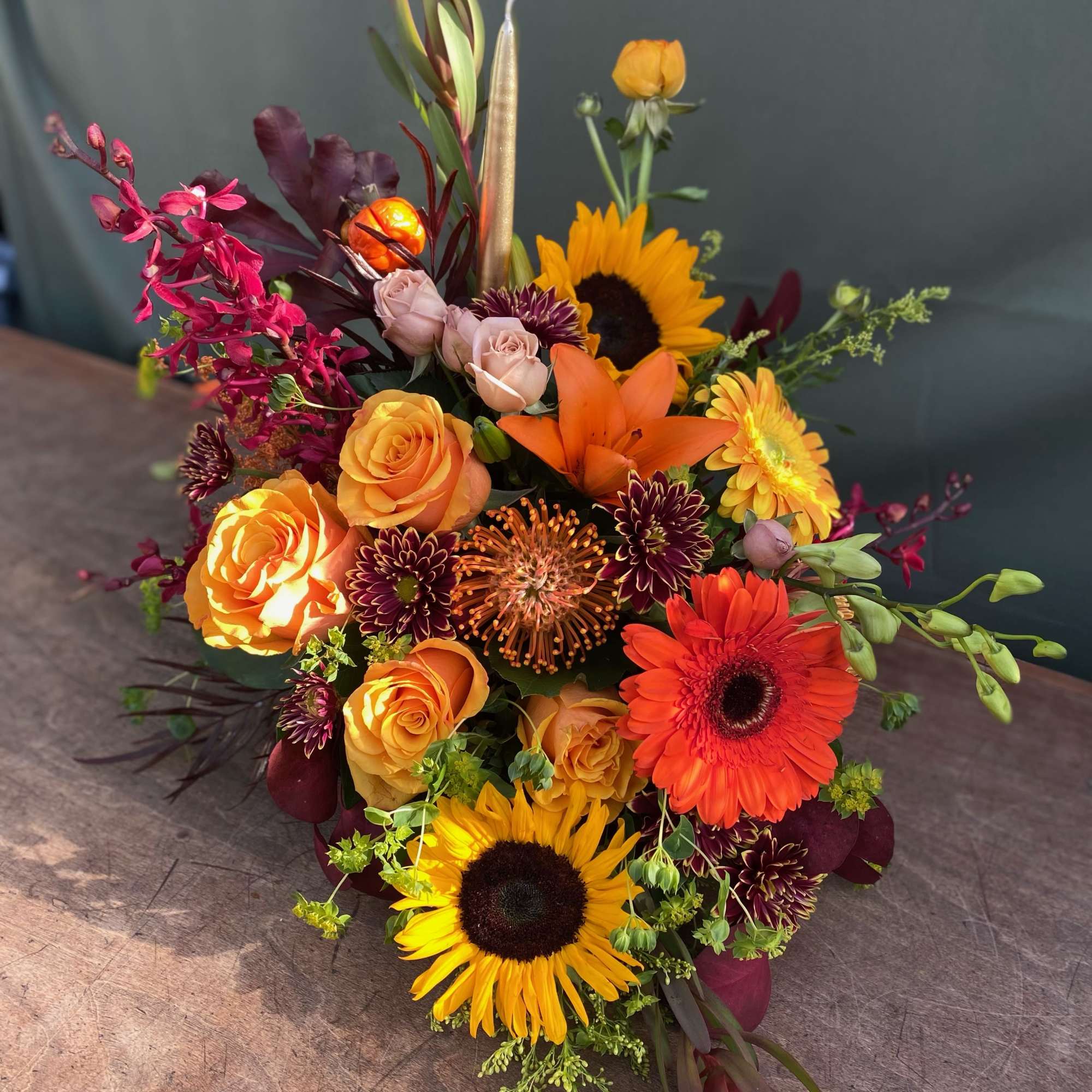 This arrangement include a variety of fall flowers, perfect for your thanksgiving