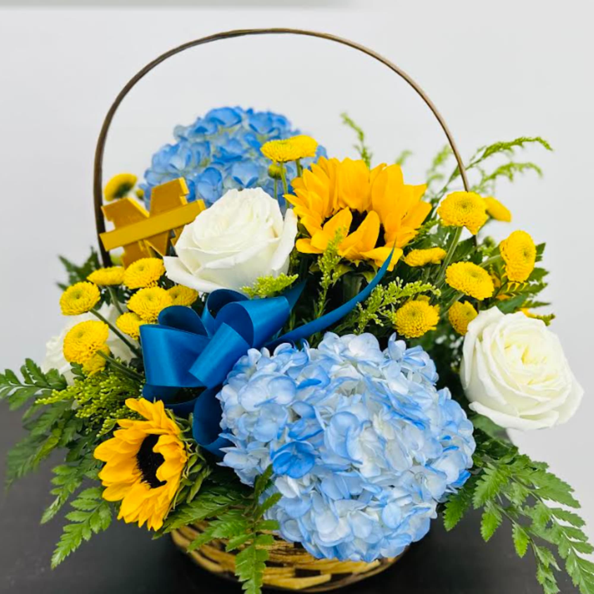 Sunflowers and Blue Hydrangeas with a mix of other flowers and greens