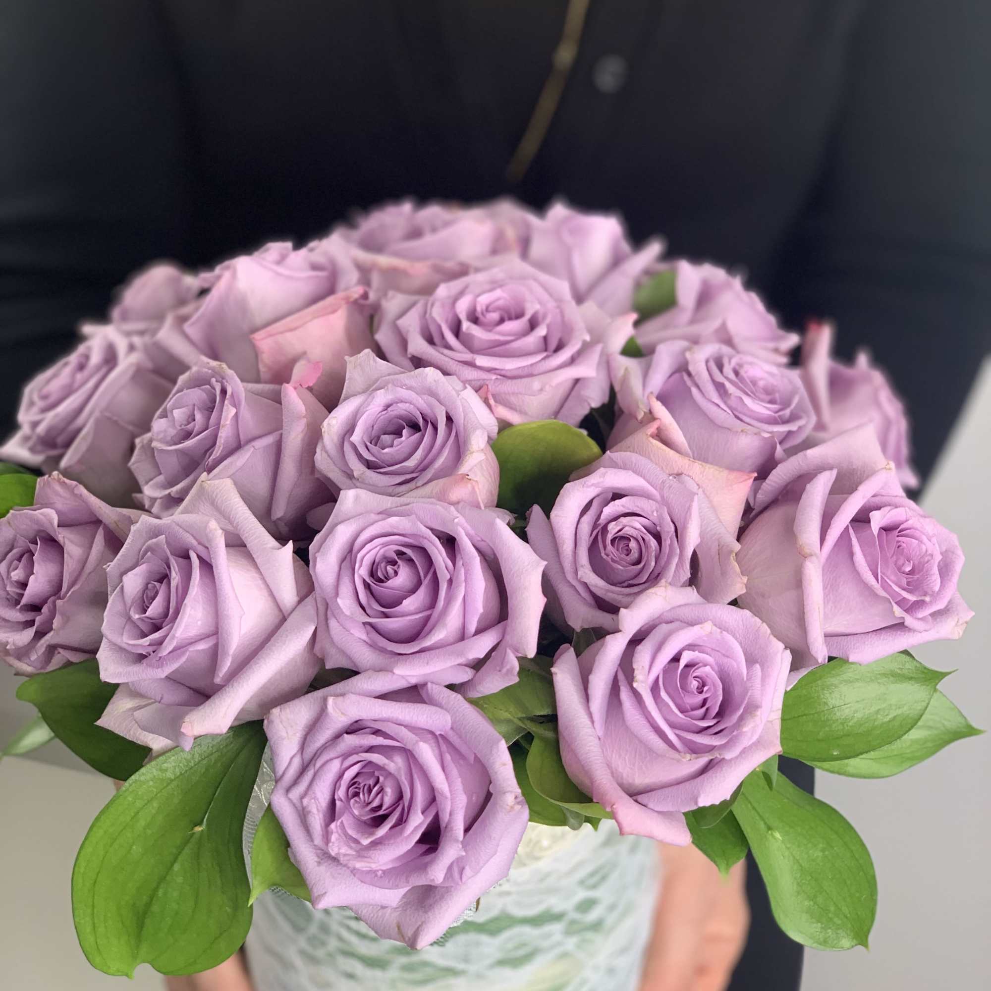 These lavender roses are stunning arranged in a cylinder vase for your