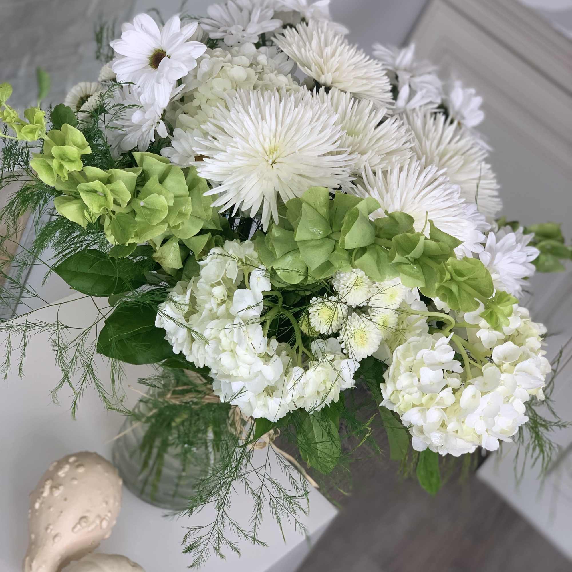 This arrangement is full of variety of daisies and asters with hydrangeas
