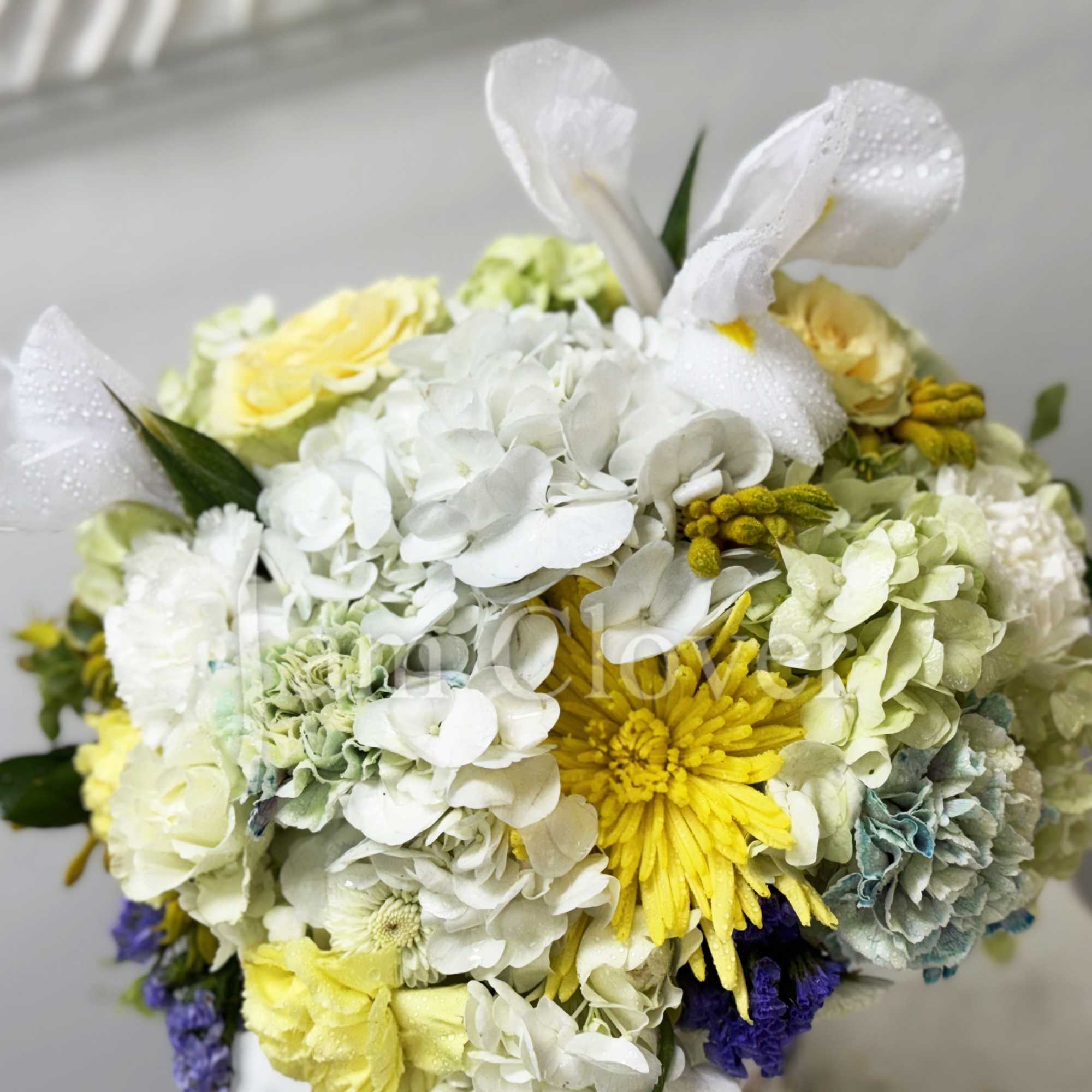 This romantic arrangement has a light European fleur containing blush yellow and
