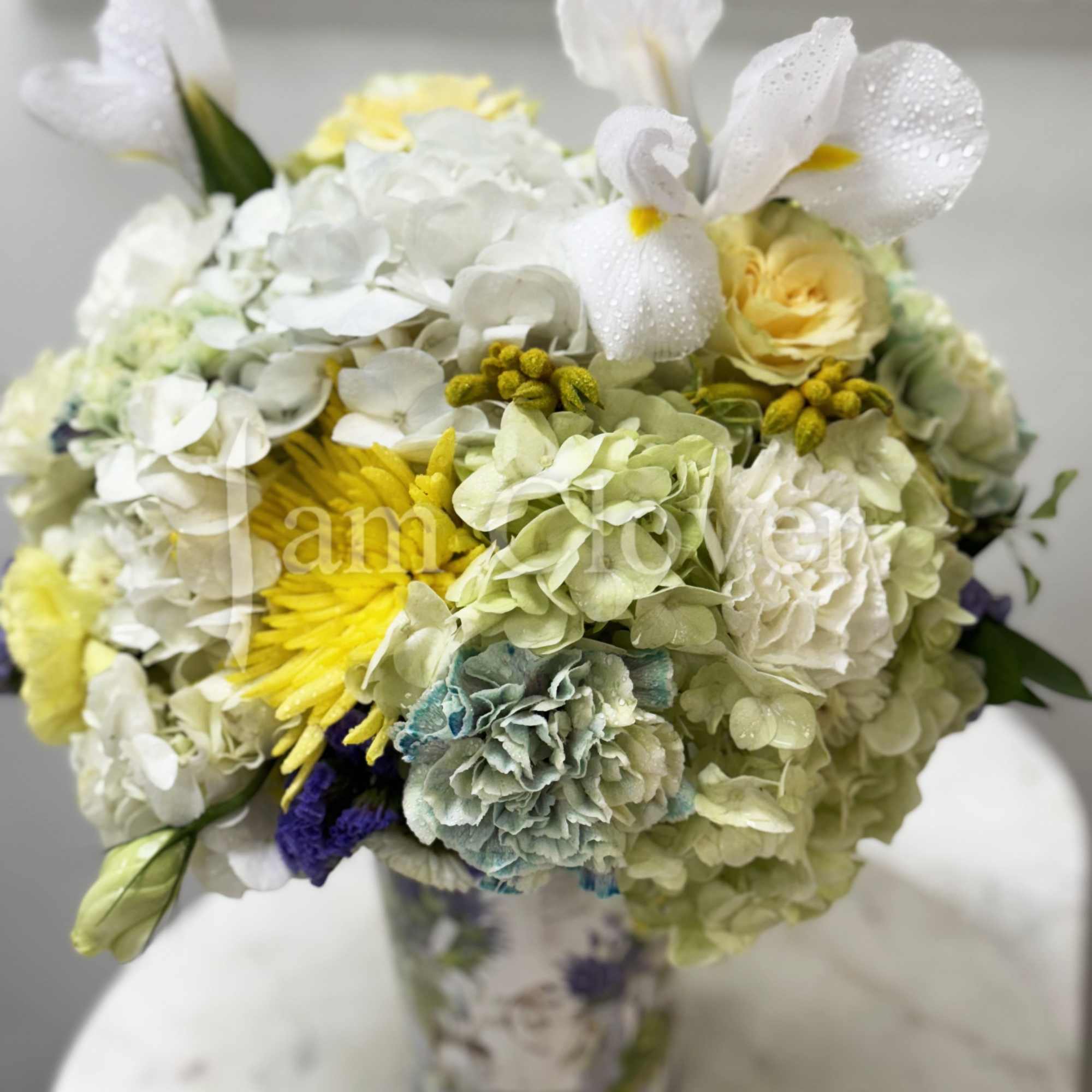 This romantic arrangement has a light European fleur containing blush yellow and