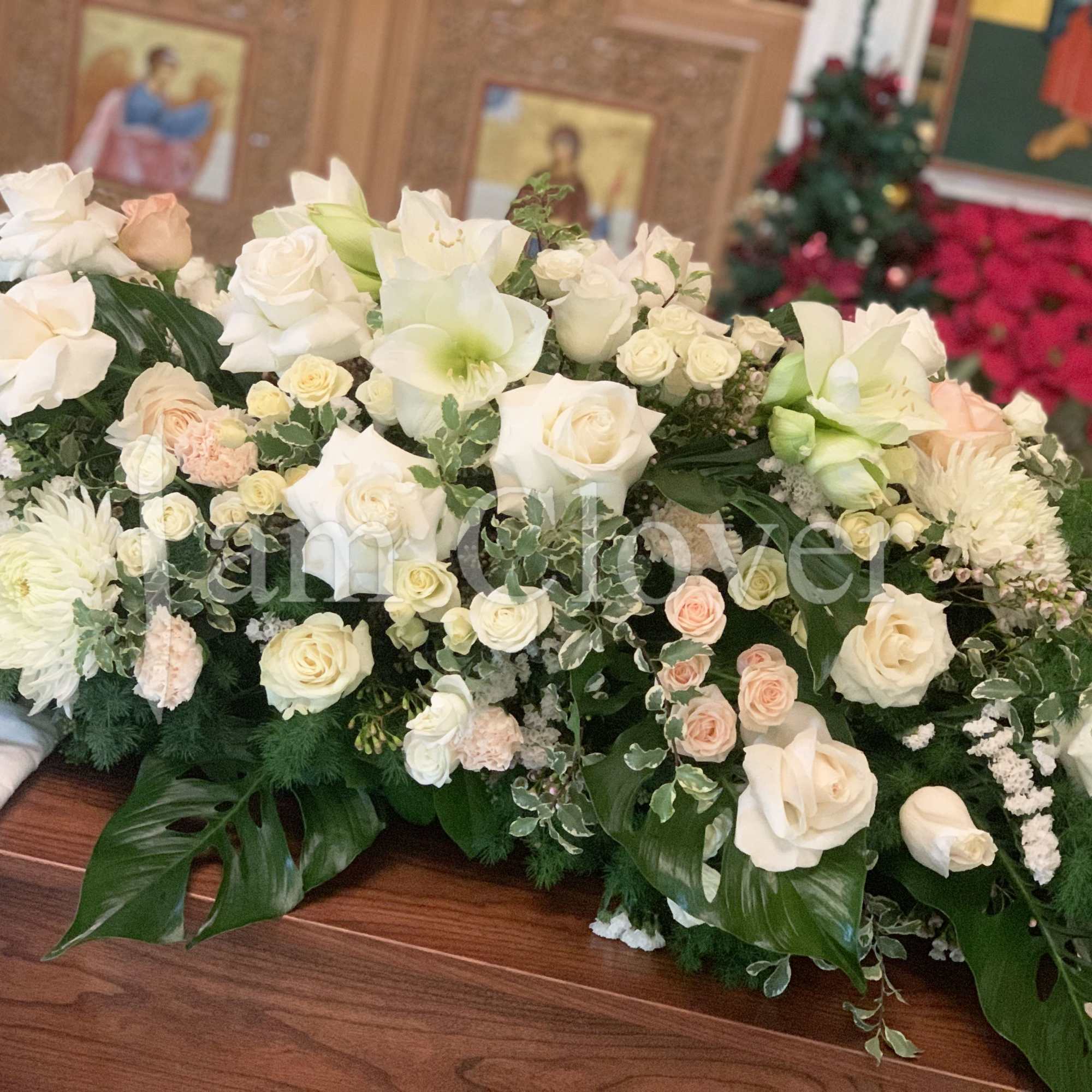 This is a grand, beautiful, and lush casket spray with white and