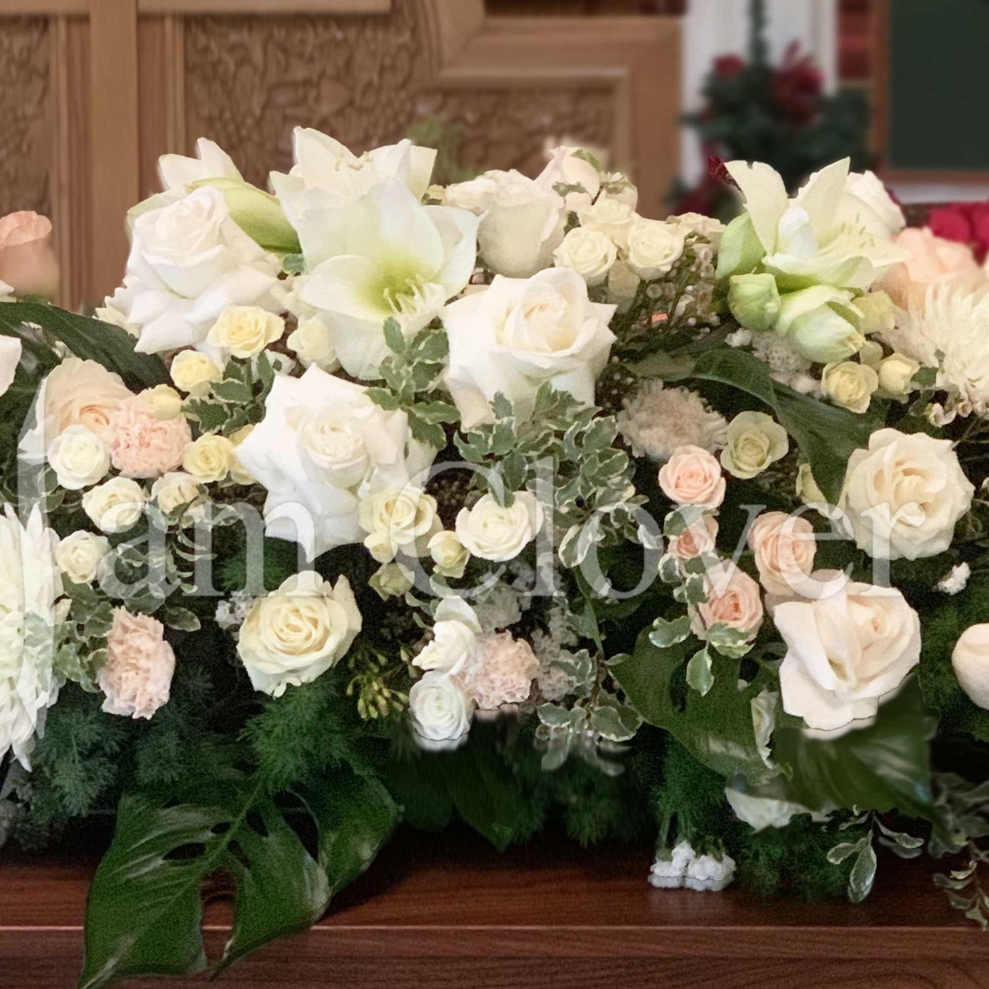 This is a grand, beautiful, and lush casket spray with white and