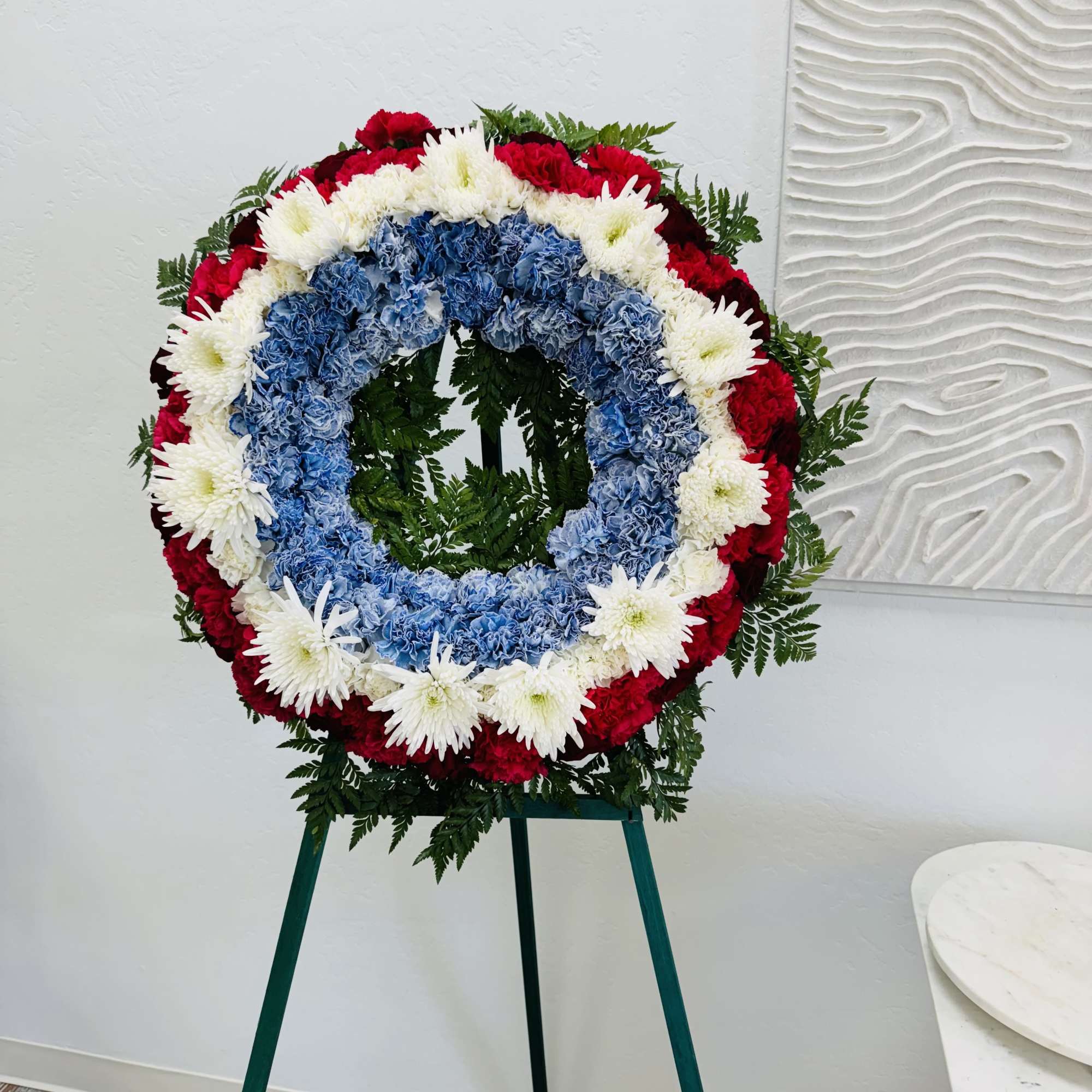 Patriotic Standing Wreath
A tasteful and elegant funeral arrangement that honors your loved