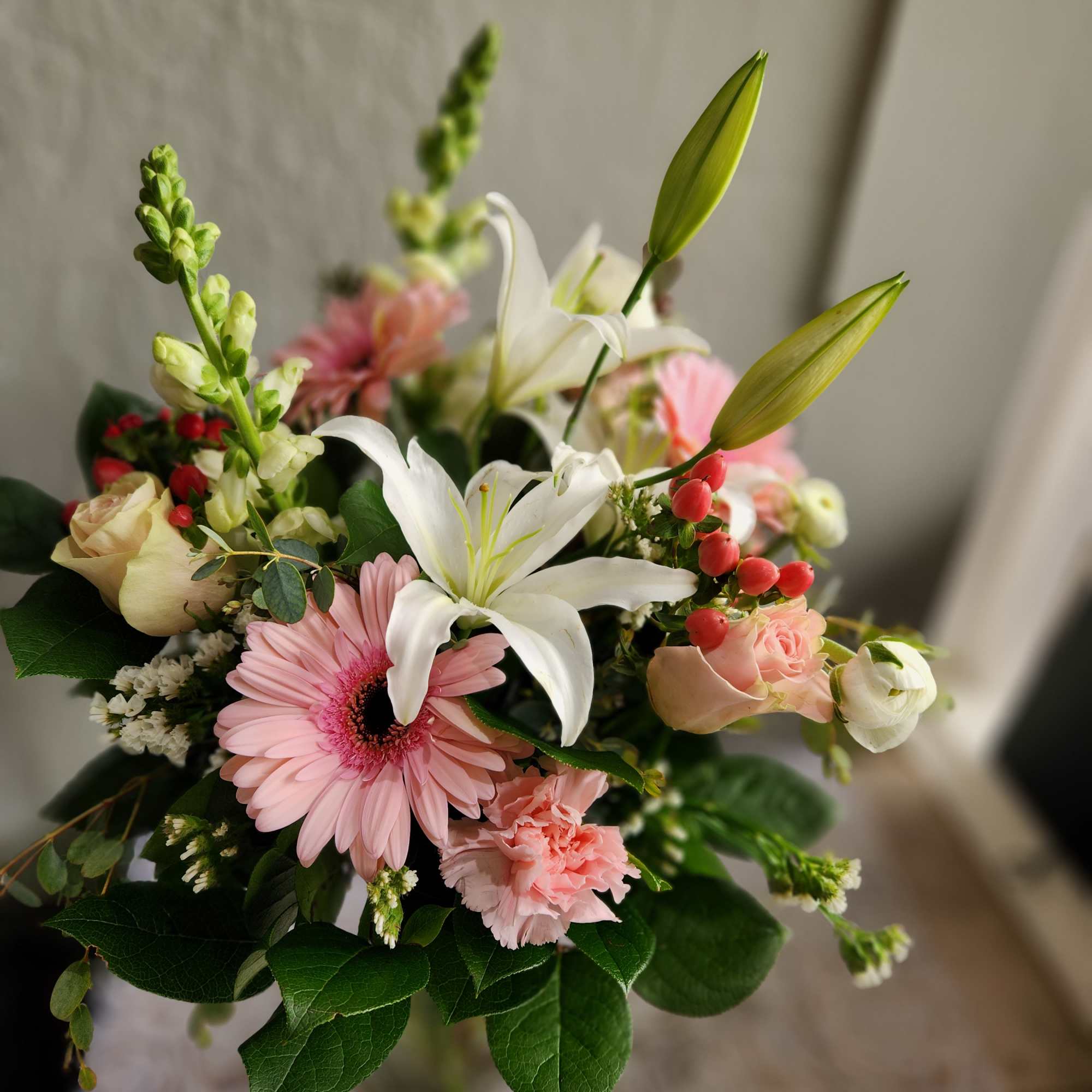 A beautiful soft pinks and whites in season blooms. This Arrangement is