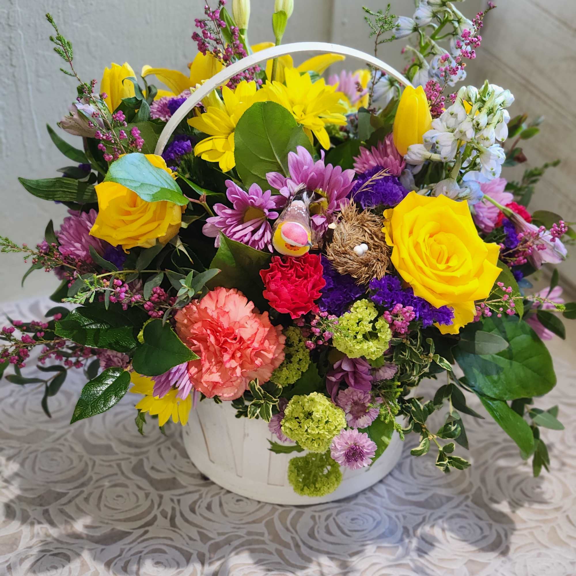 A cute spring basket with bright colors accented with curly willow and