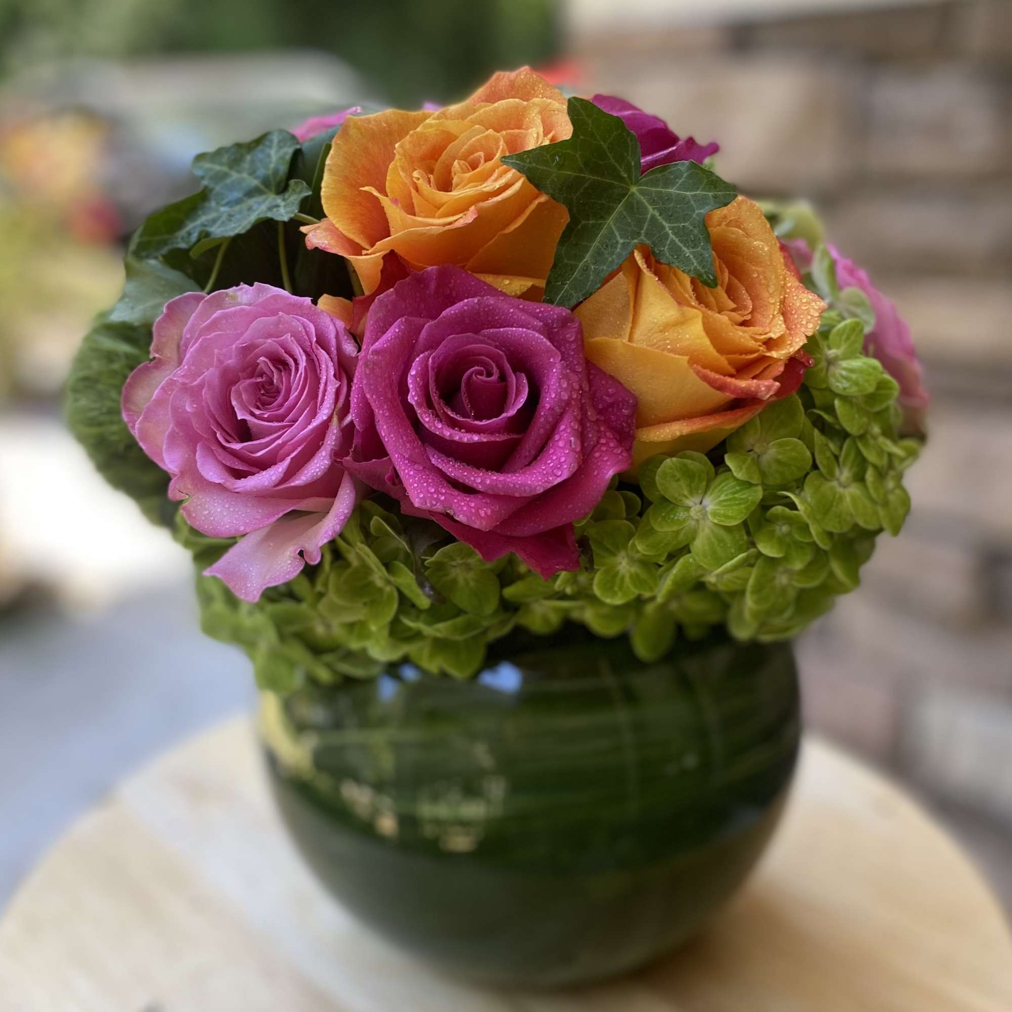 Brighten any space with this vibrant floral arrangement featuring bold orange and Brighten any space with this vibrant floral arrangement featuring bold orange and