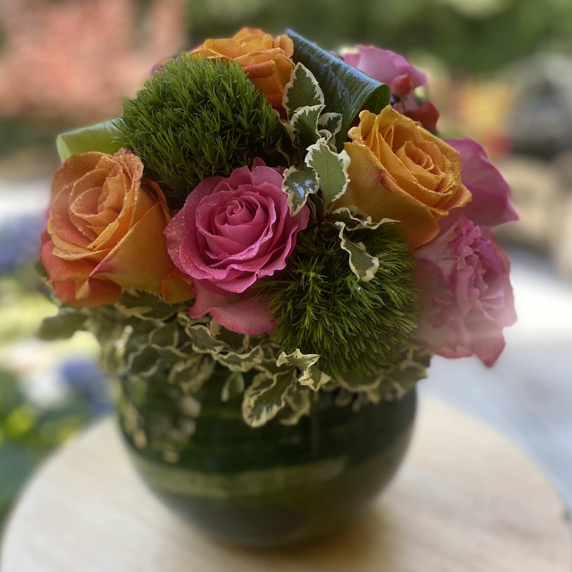 Brighten any space with this vibrant floral arrangement featuring bold orange and Brighten any space with this vibrant floral arrangement featuring bold orange and