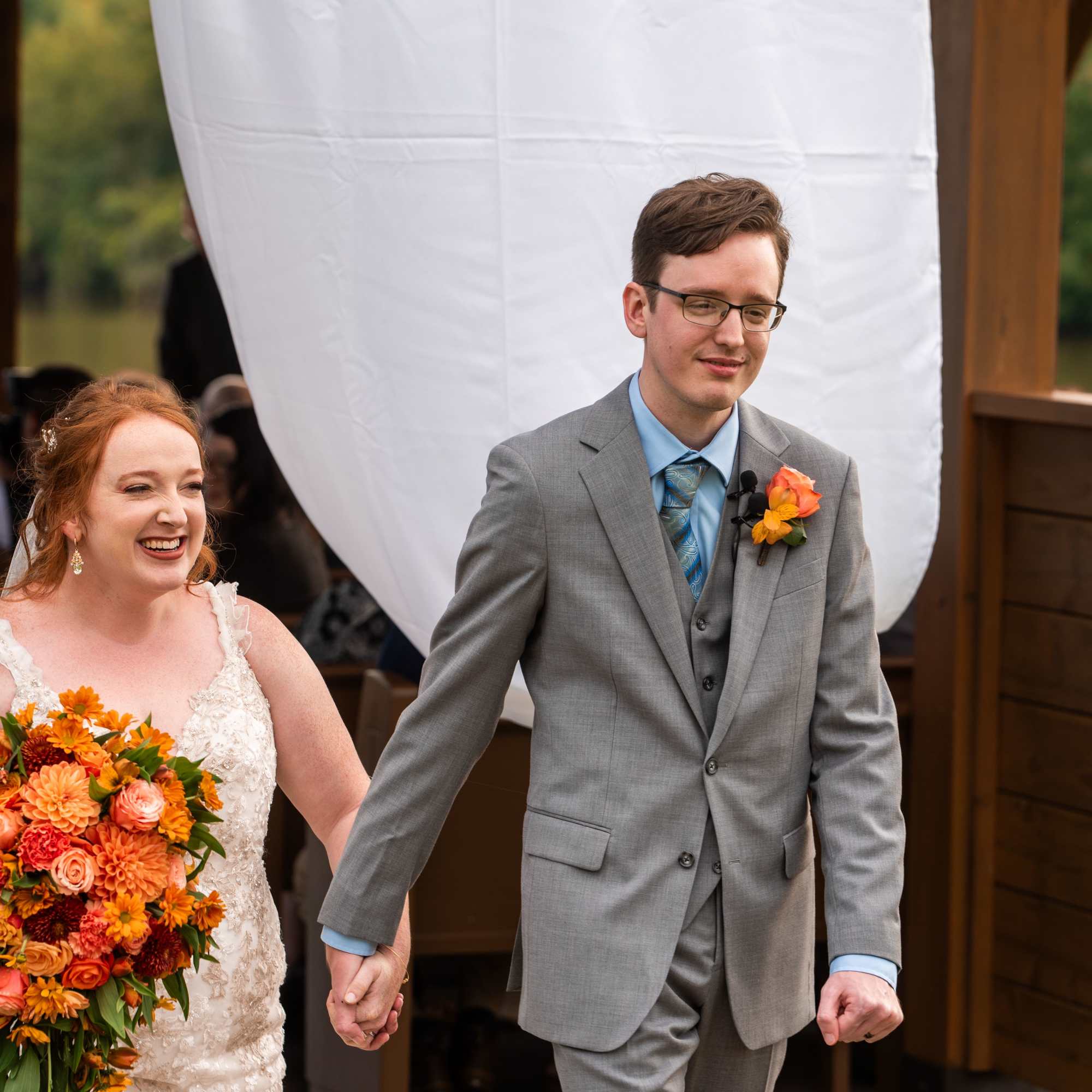 Beautiful reach  orange sunset color bridal cascade with roses, dahlias, carnations