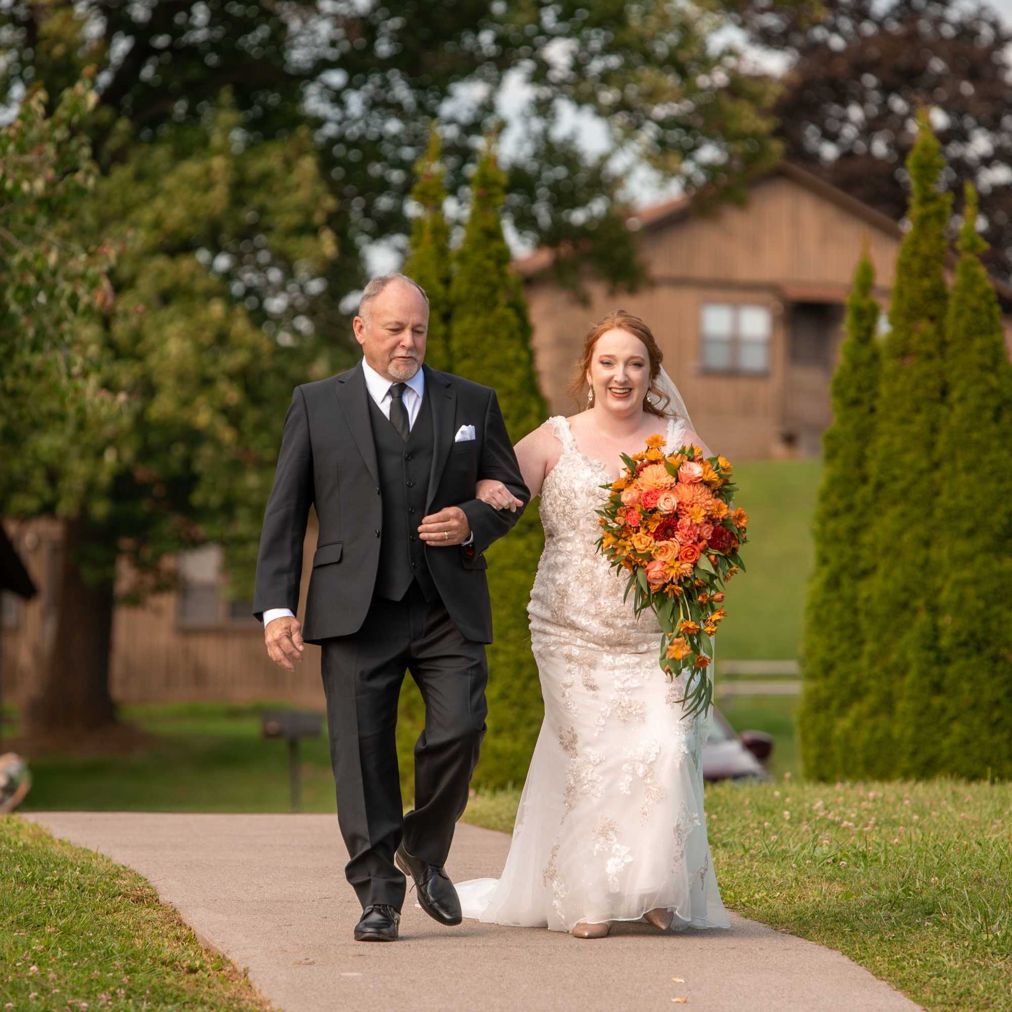 Beautiful reach  orange sunset color bridal cascade with roses, dahlias, carnations