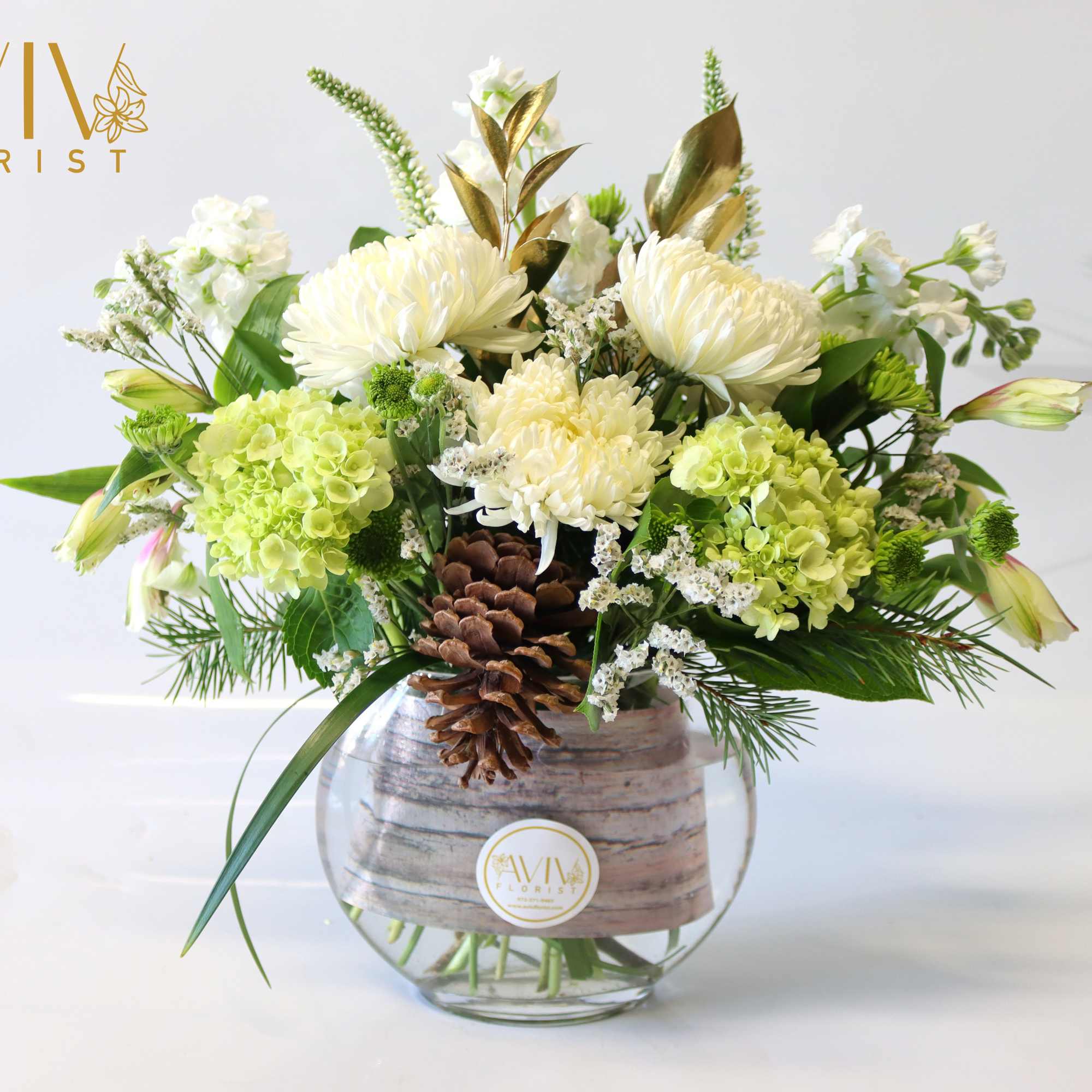 Green Hydrangea, white cremon, white alstroemeria, white veronica, white stock, and pine
