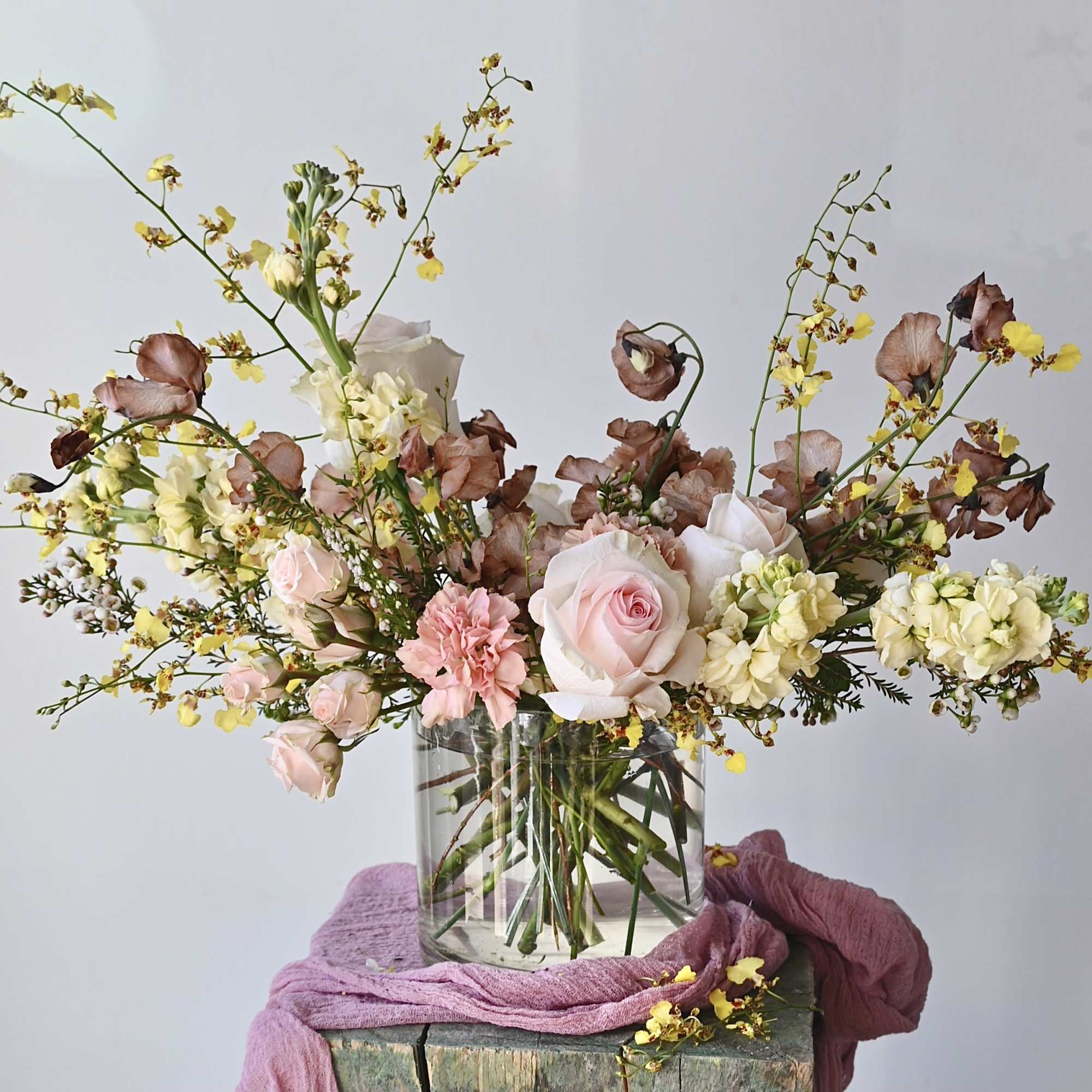 Designed in our signature style: a lush garden-style mix of seasonal blooms