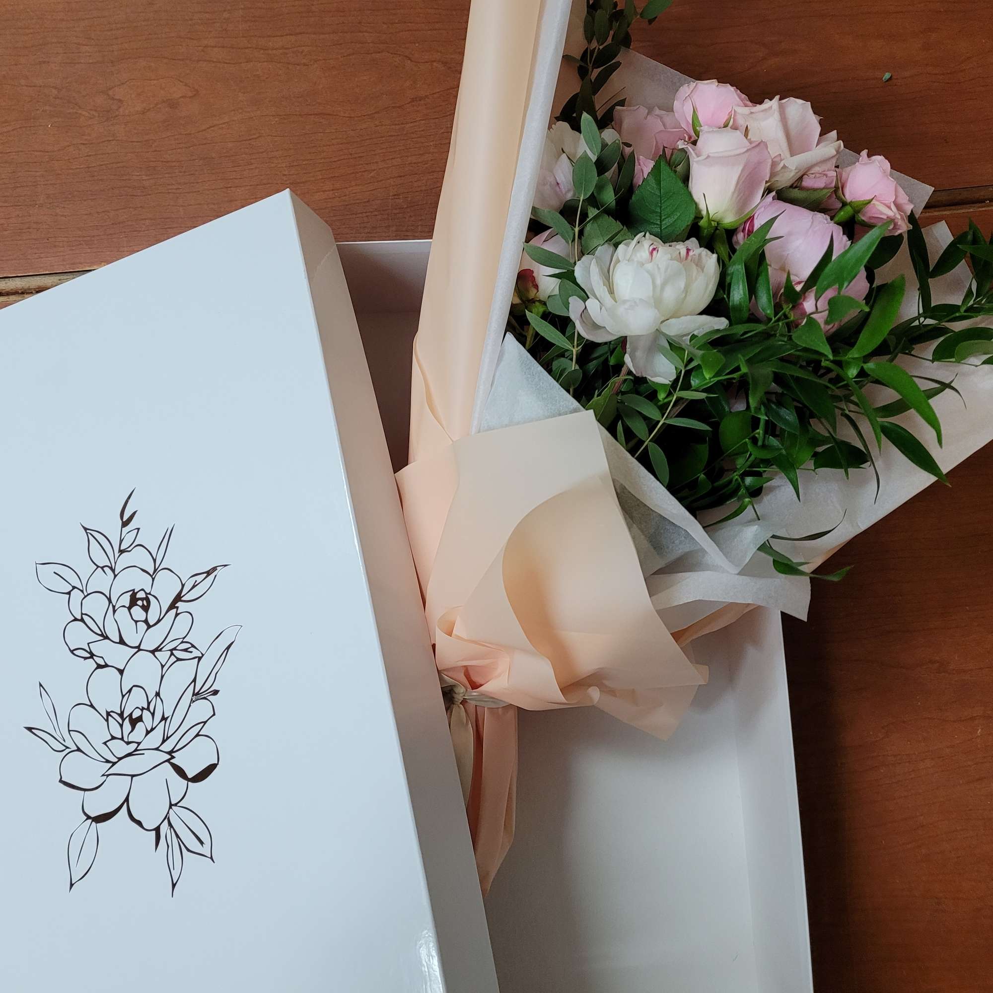 a collection of seasonally available blooms wrapped in our specialty wrapping and